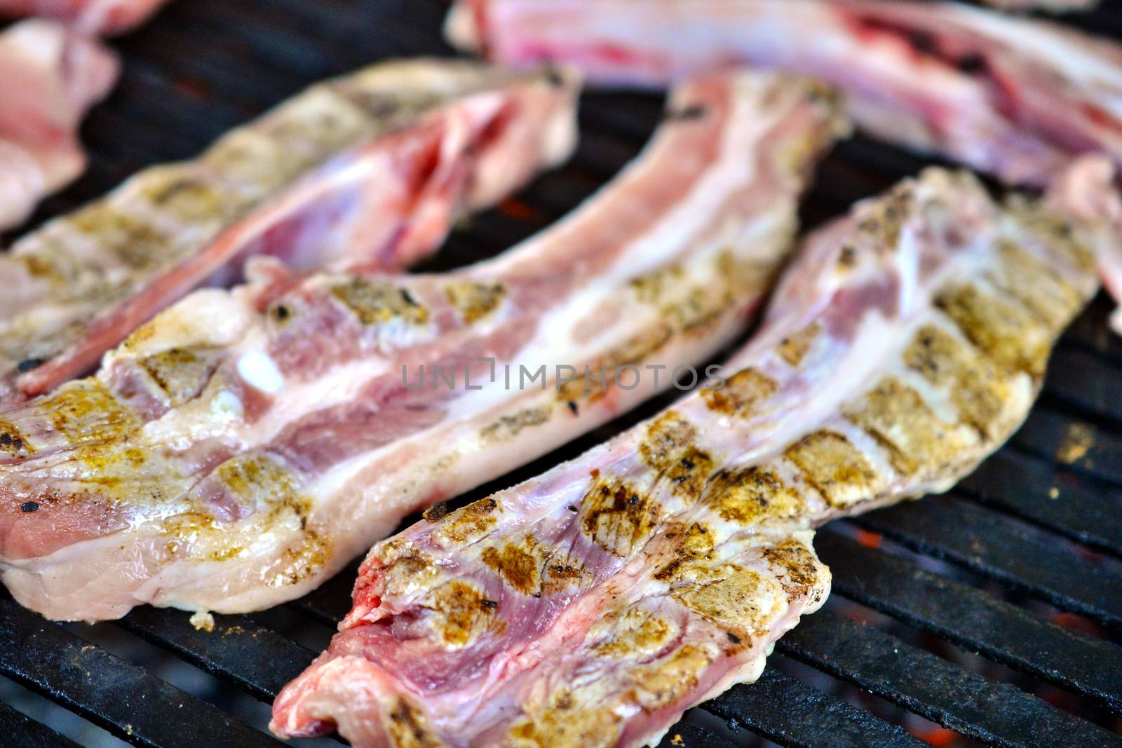 preparing meat on a coal barbeque by nehru