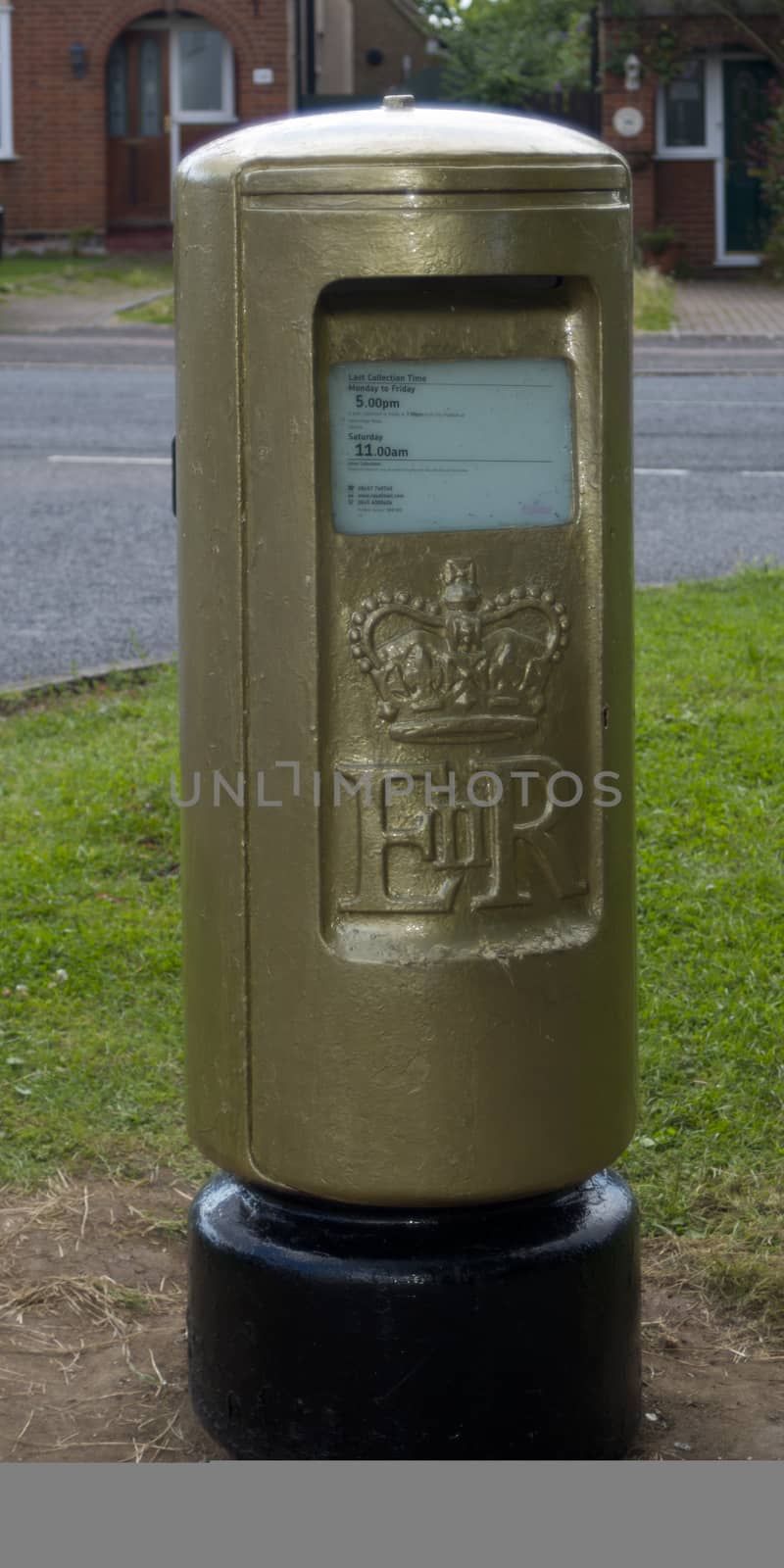 STOTFOLD, BEDFORDSHIRE, UK - AUGUST 8: Golden Postbox to commemorate Victoria Pendleton's Keirin Cycling Gold Medal at London 2012 Olympics on 3 August 2012