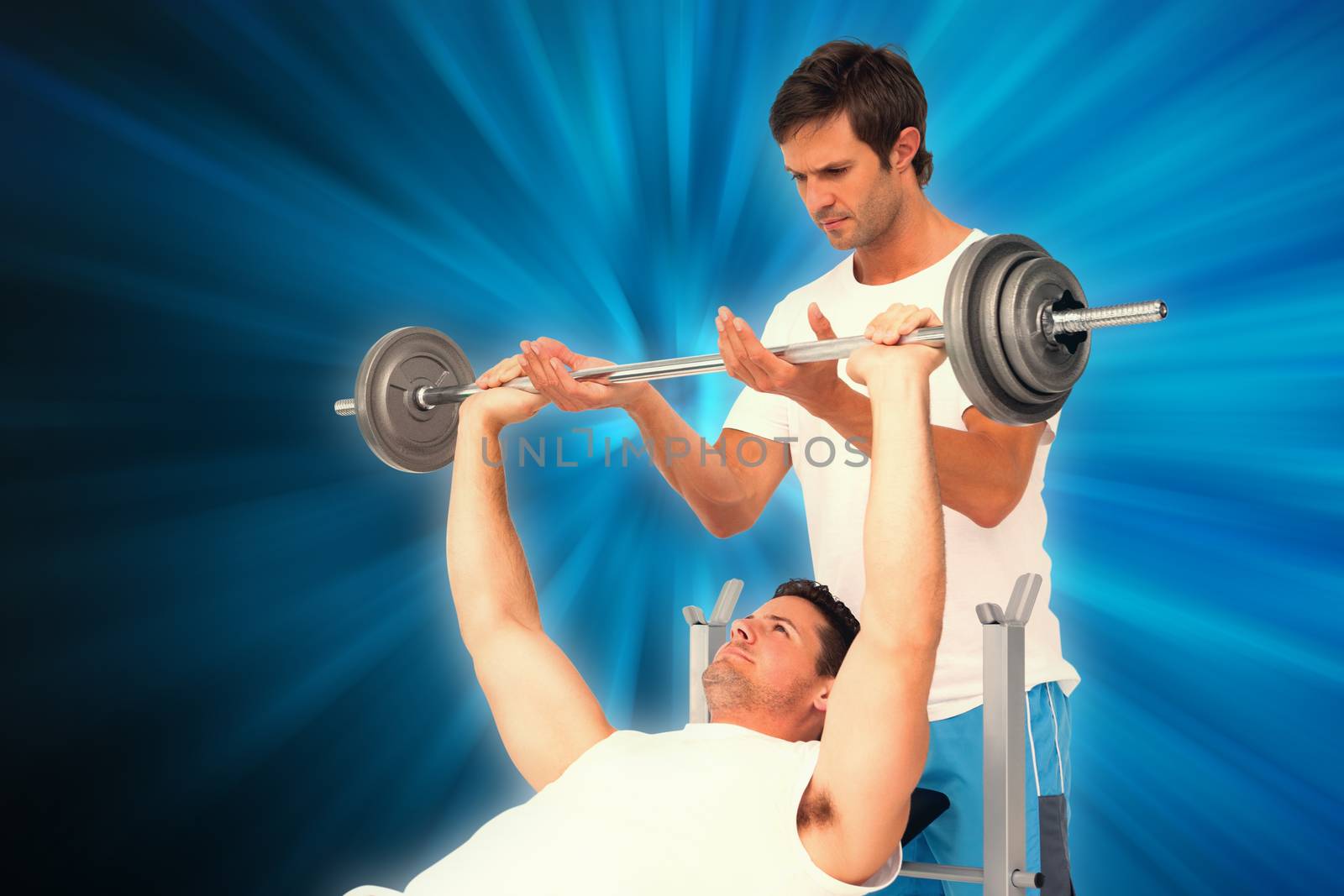 Trainer helping fit man to lift the barbell bench press against abstract background