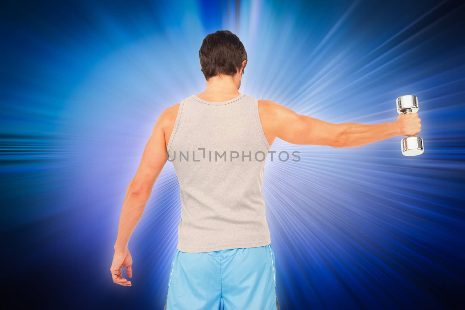 Composite image of rear view of a young man holding out dumbbell by Wavebreakmedia