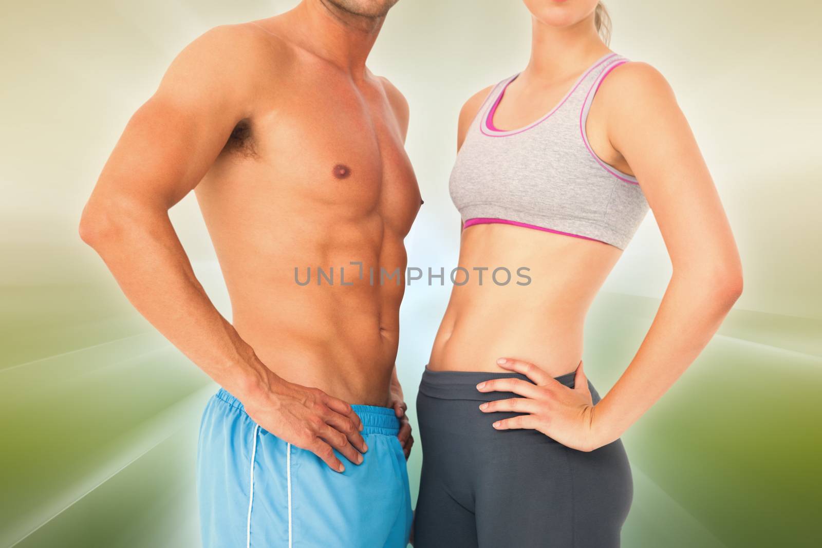Mid section of a fit young couple against abstract background