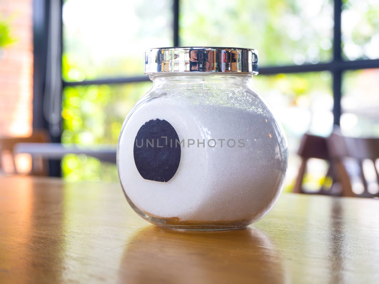 sugar in  glass jar on wood table for coffee.