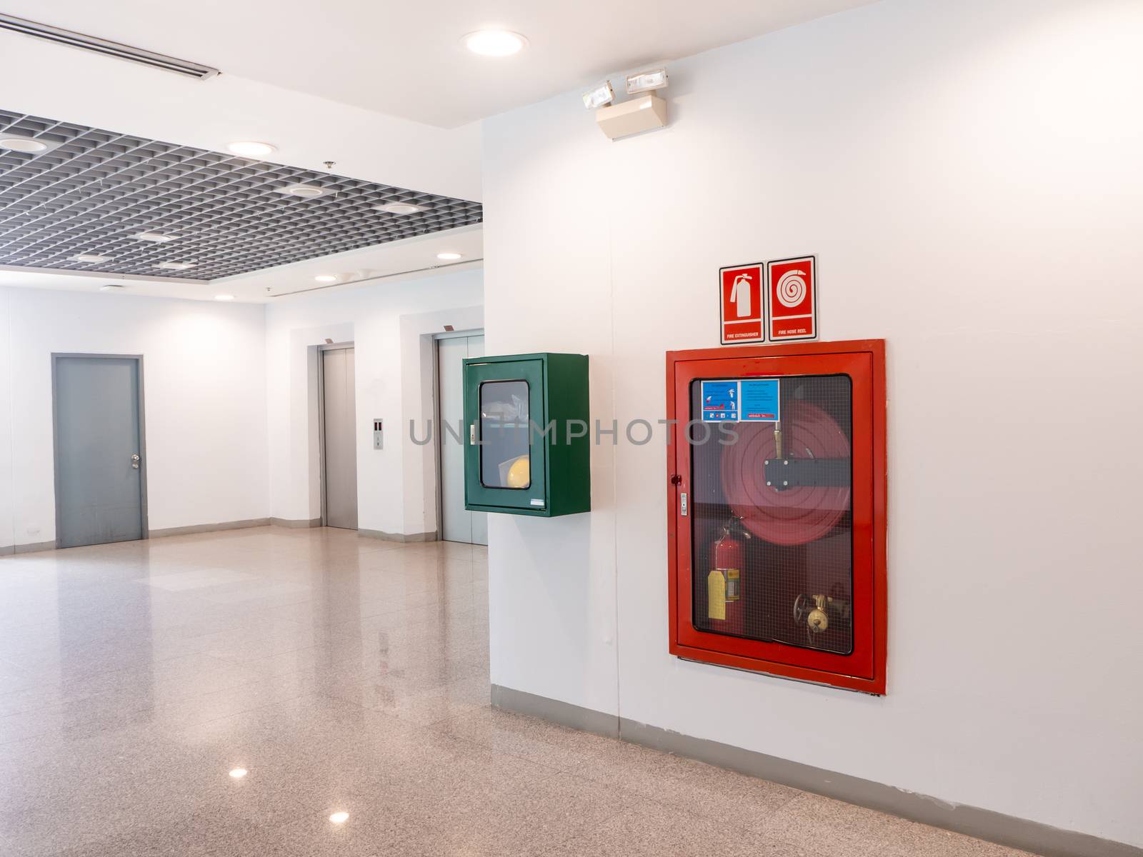 fire extinguisher cabinet in the office building  by shutterbird