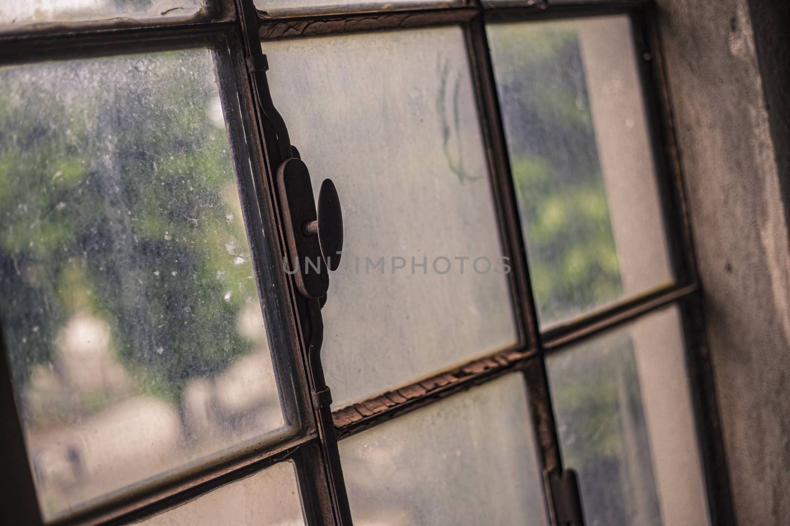 Old, rusty and dirty window detail in an abandoned building