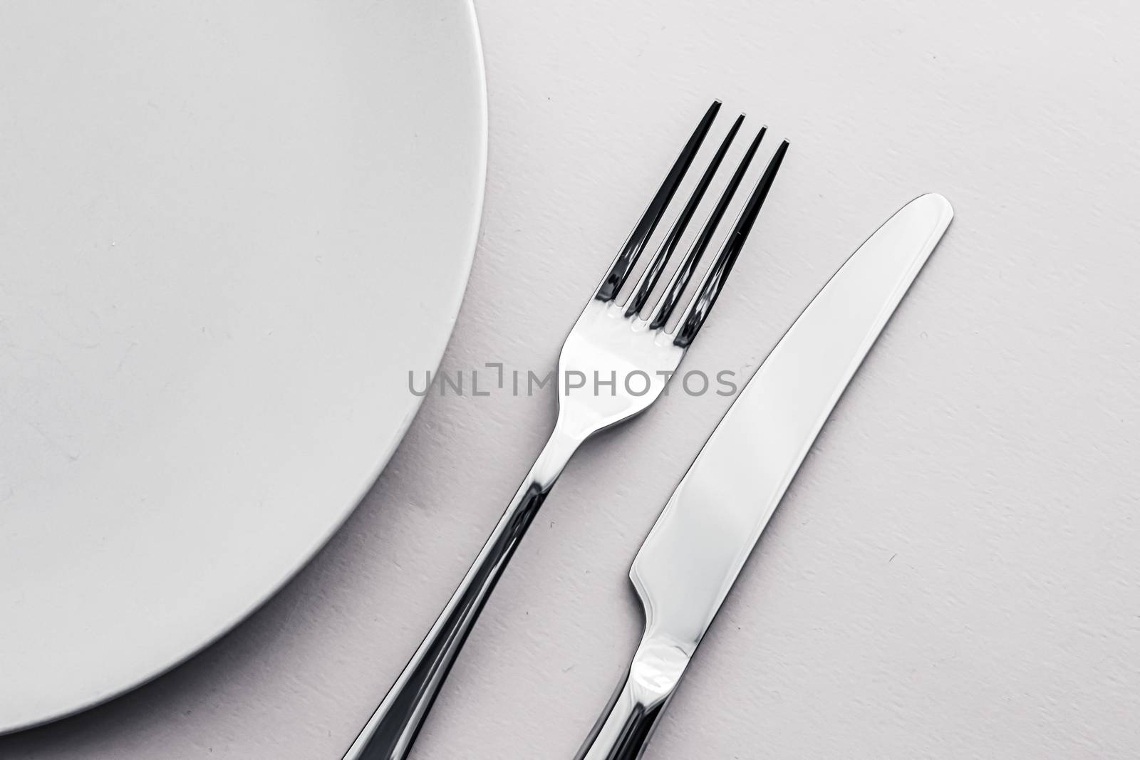 Empty plate and cutlery as mockup set on white background, top tableware for chef table decor and menu branding design