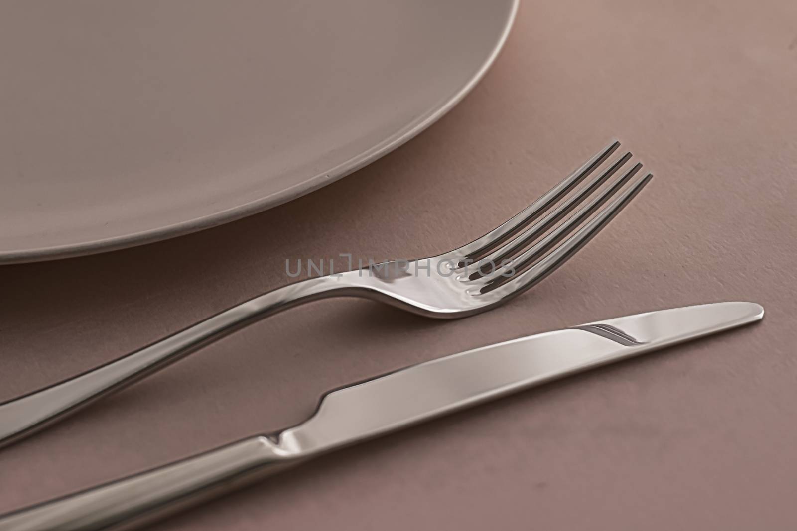 Empty plate and cutlery as mockup set on brown background, top tableware for chef table decor and menu branding design