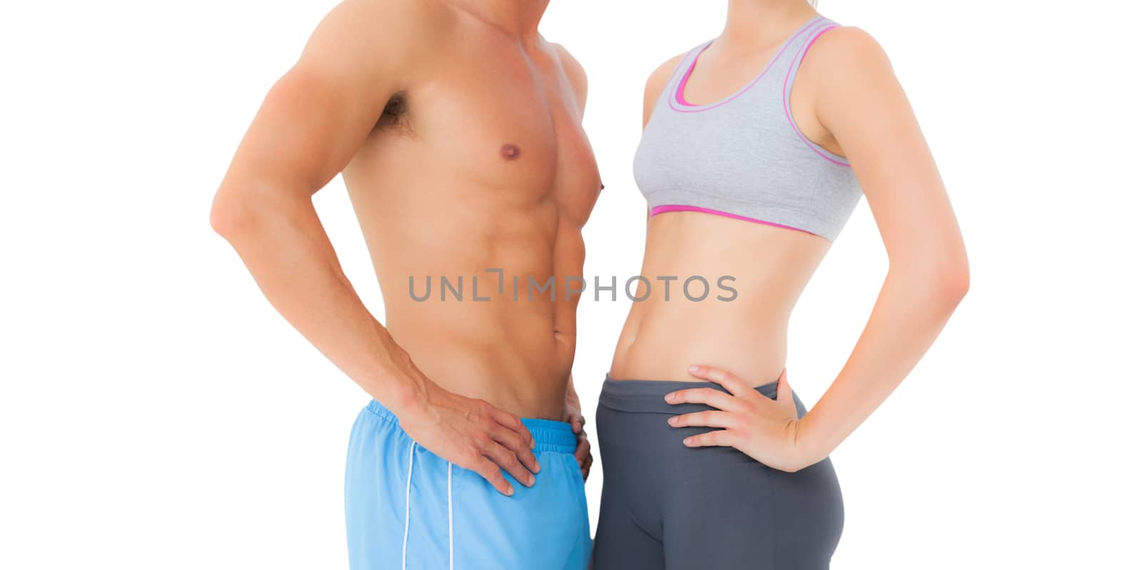Mid section of a fit young couple standing over white background