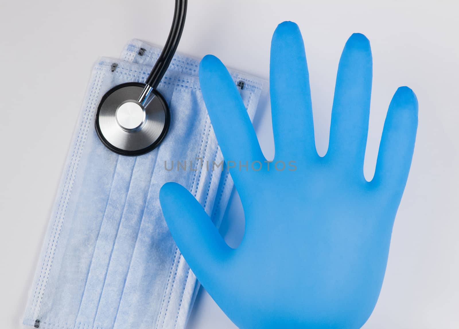 Medical masks and gloves on a white background, with a stethoscope. Coronavirus Protection Concept