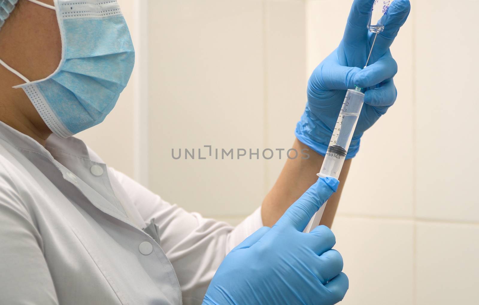 Doctor prepares a syringe with an injection, close-up