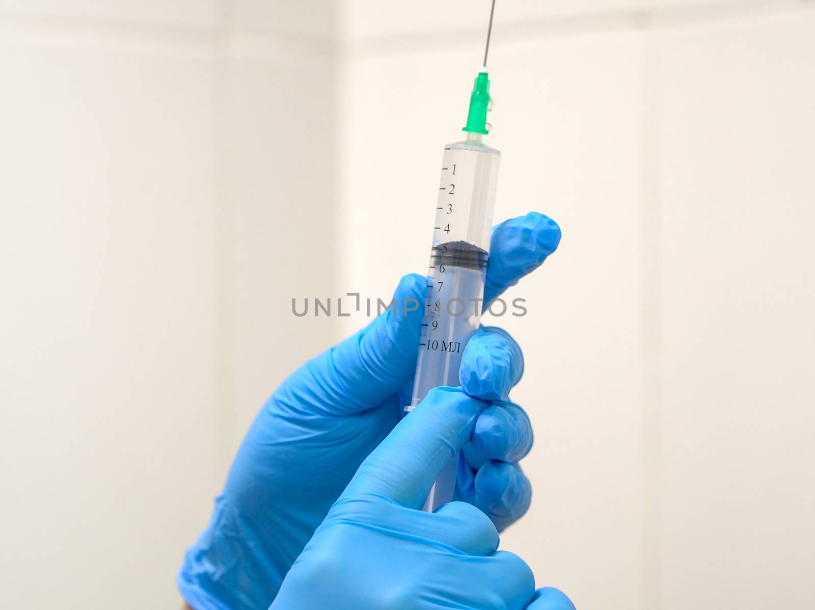 Doctor prepares a syringe with an injection, close-up