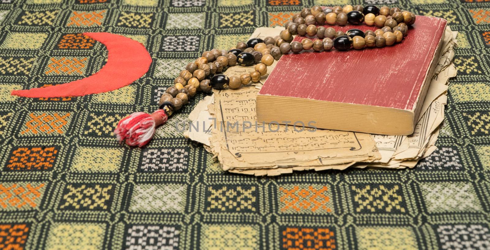 Muslim prayer beads with Quran and with sheets with ancient Arabic scripts. Islamic and Muslim concepts