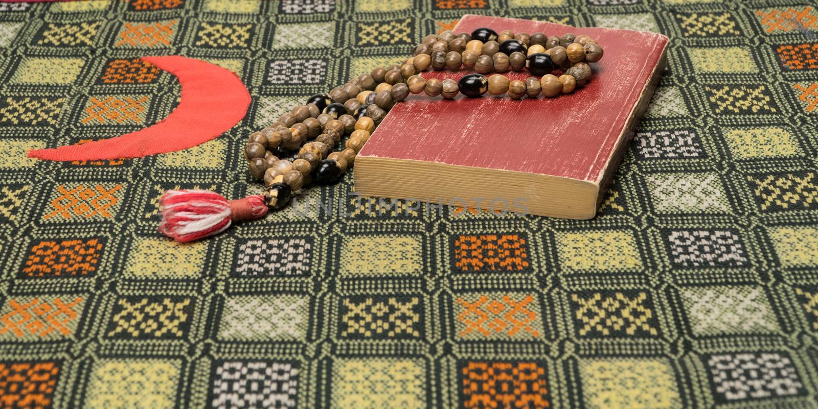 Muslim prayer beads and Koran on the prayer Mat. Islamic and Muslim concepts