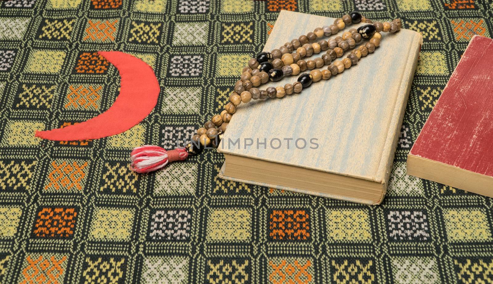 Muslim prayer beads and Quran on the prayer Mat. Islamic and Muslim concepts