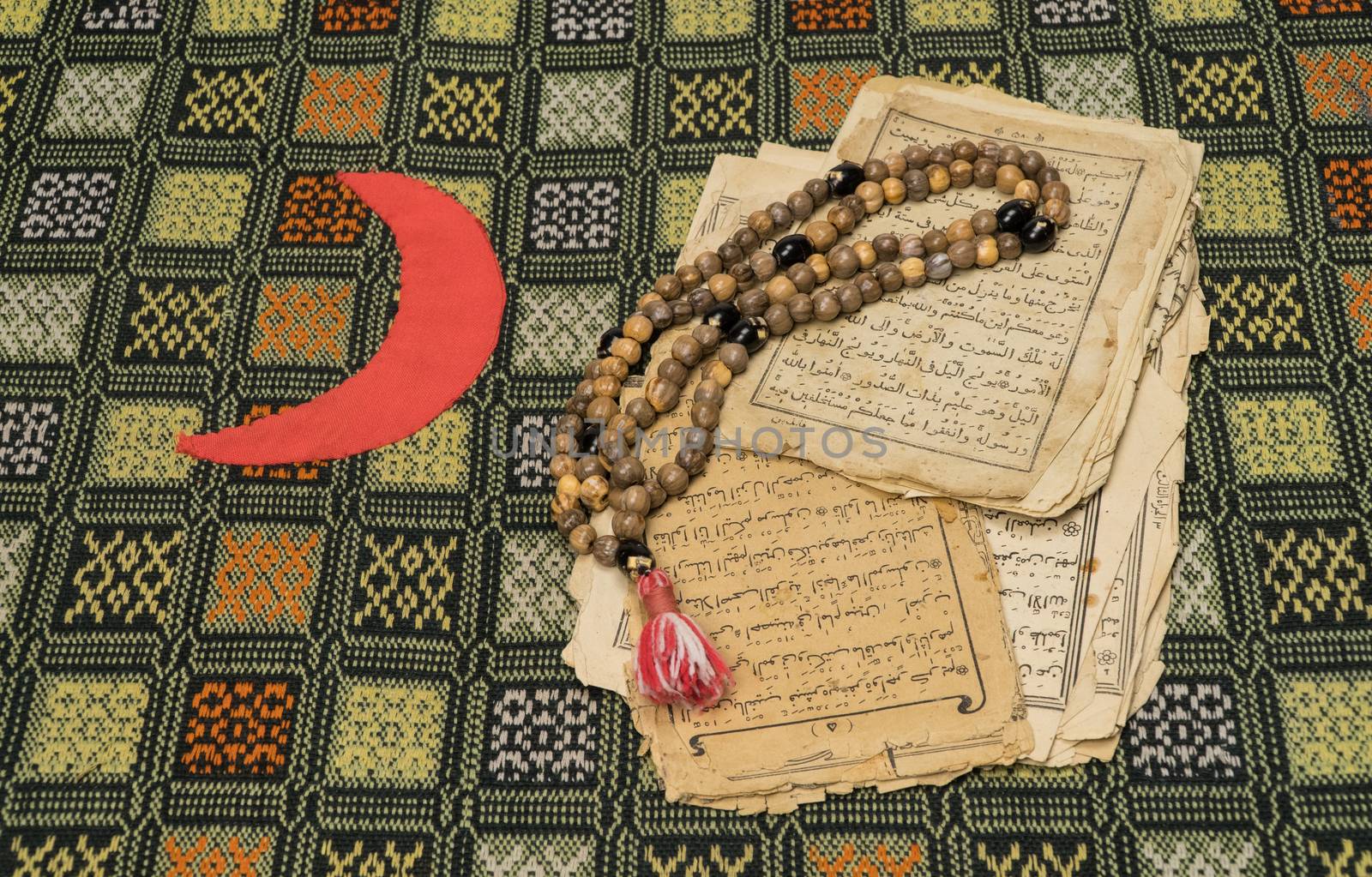 Muslim prayer beads with ancient pages from the Koran. Islamic and Muslim concepts. Ancient old sheets of paper from the Arabic book