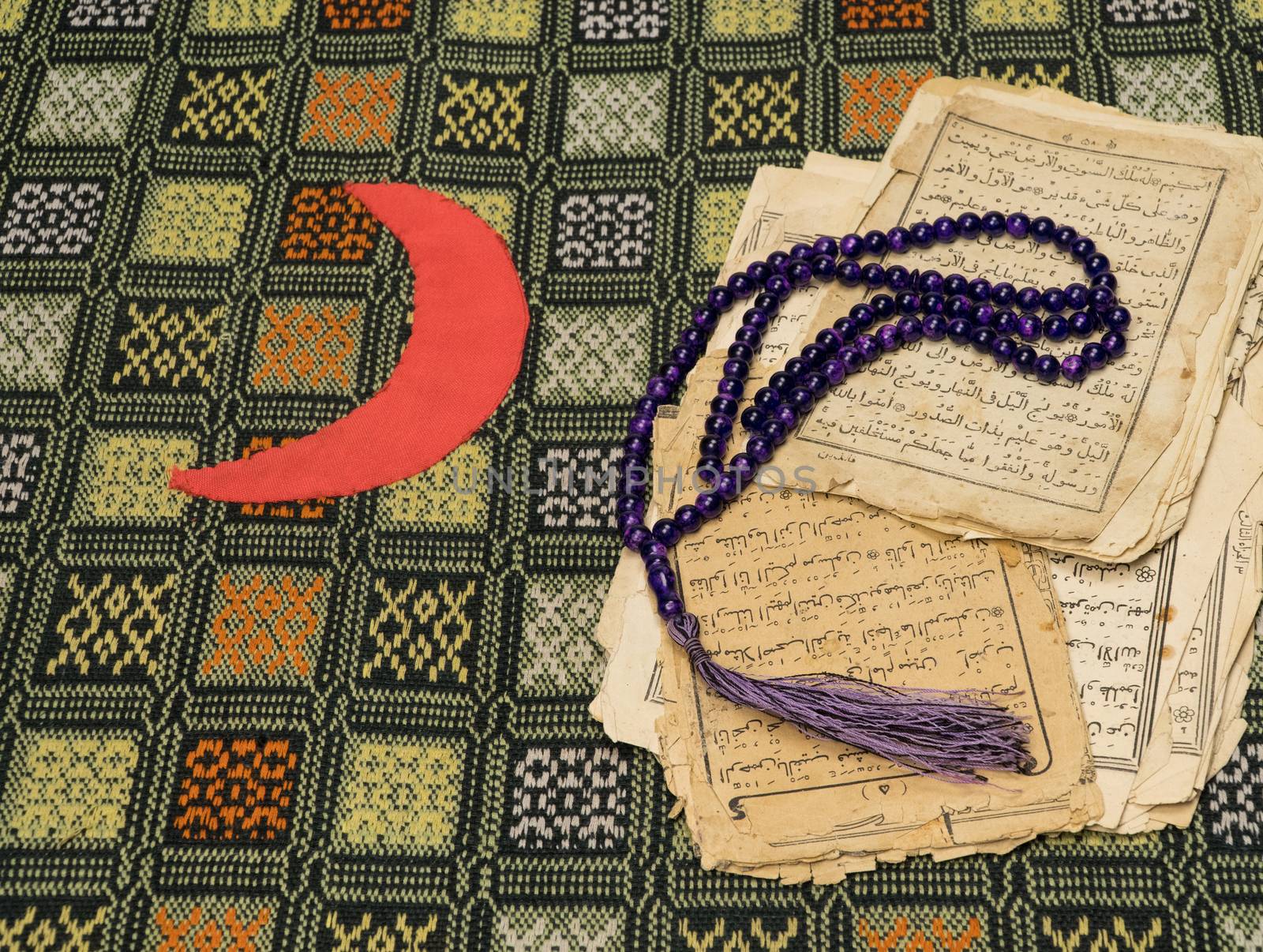 Muslim prayer beads with ancient pages from the Koran. Islamic and Muslim concepts. Ancient old sheets of paper from the Arabic book