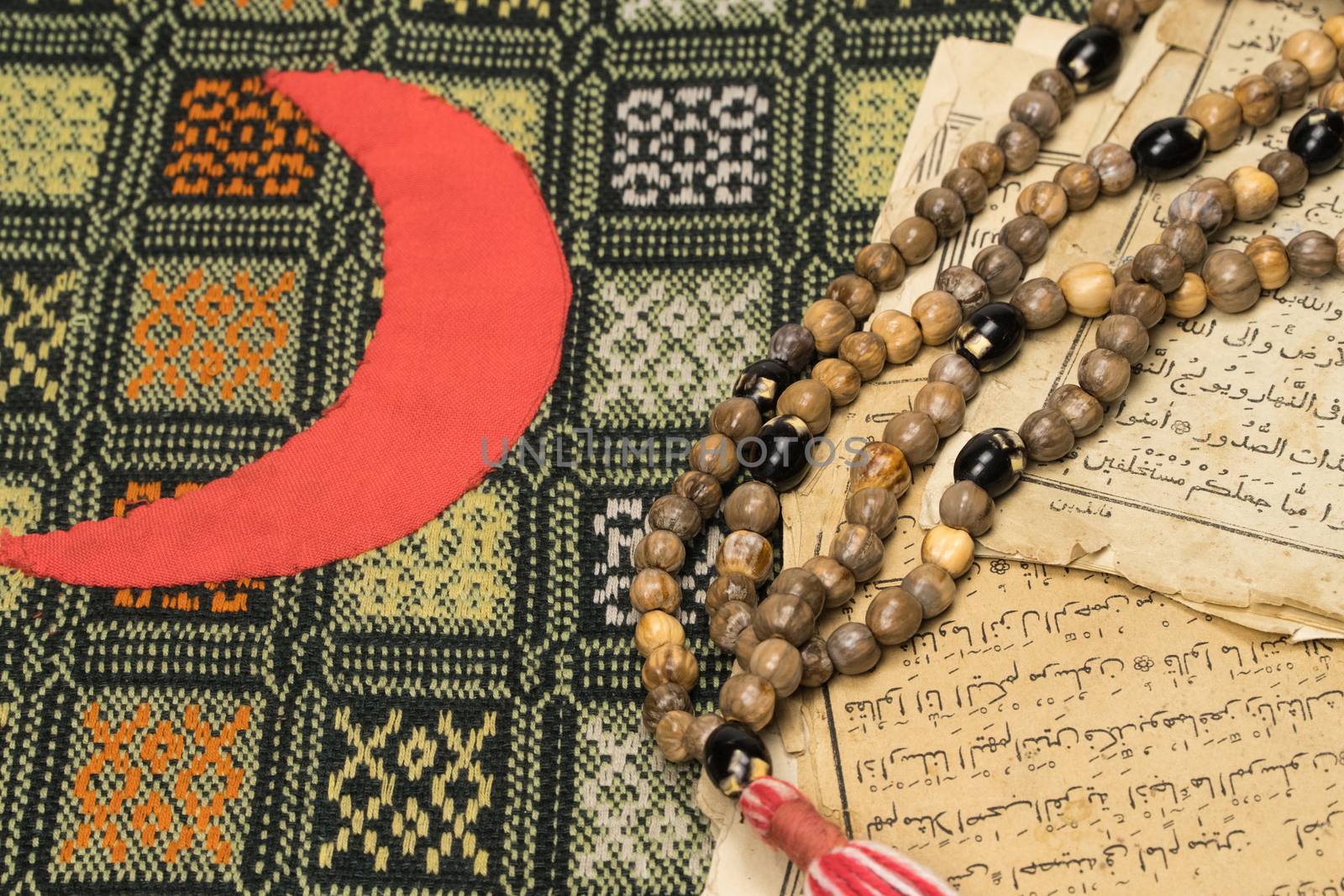 Muslim prayer beads with ancient pages from the Koran. Islamic and Muslim concepts. Ancient old sheets of paper from the Arabic book