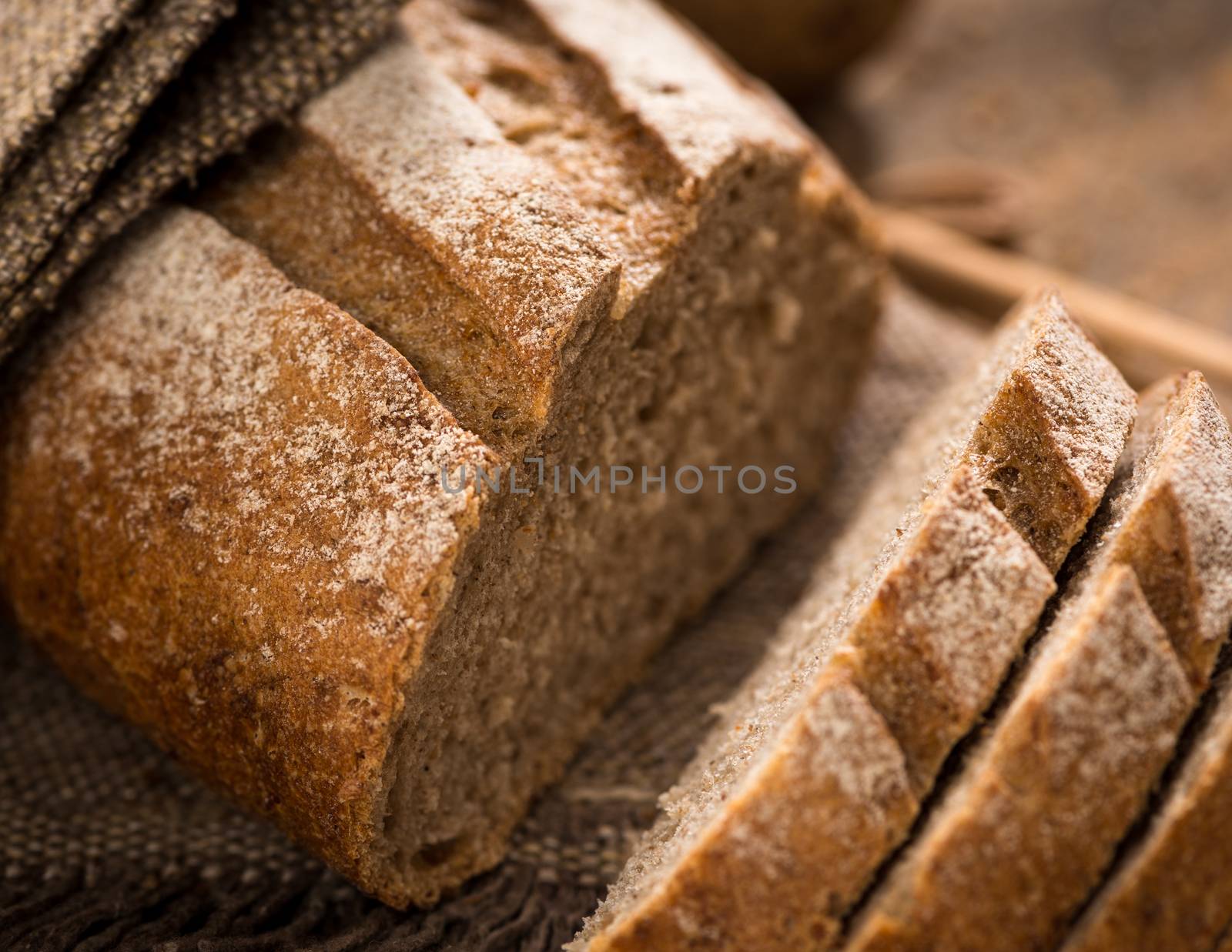 close up of sliced loaf of bread on a cloth napkin