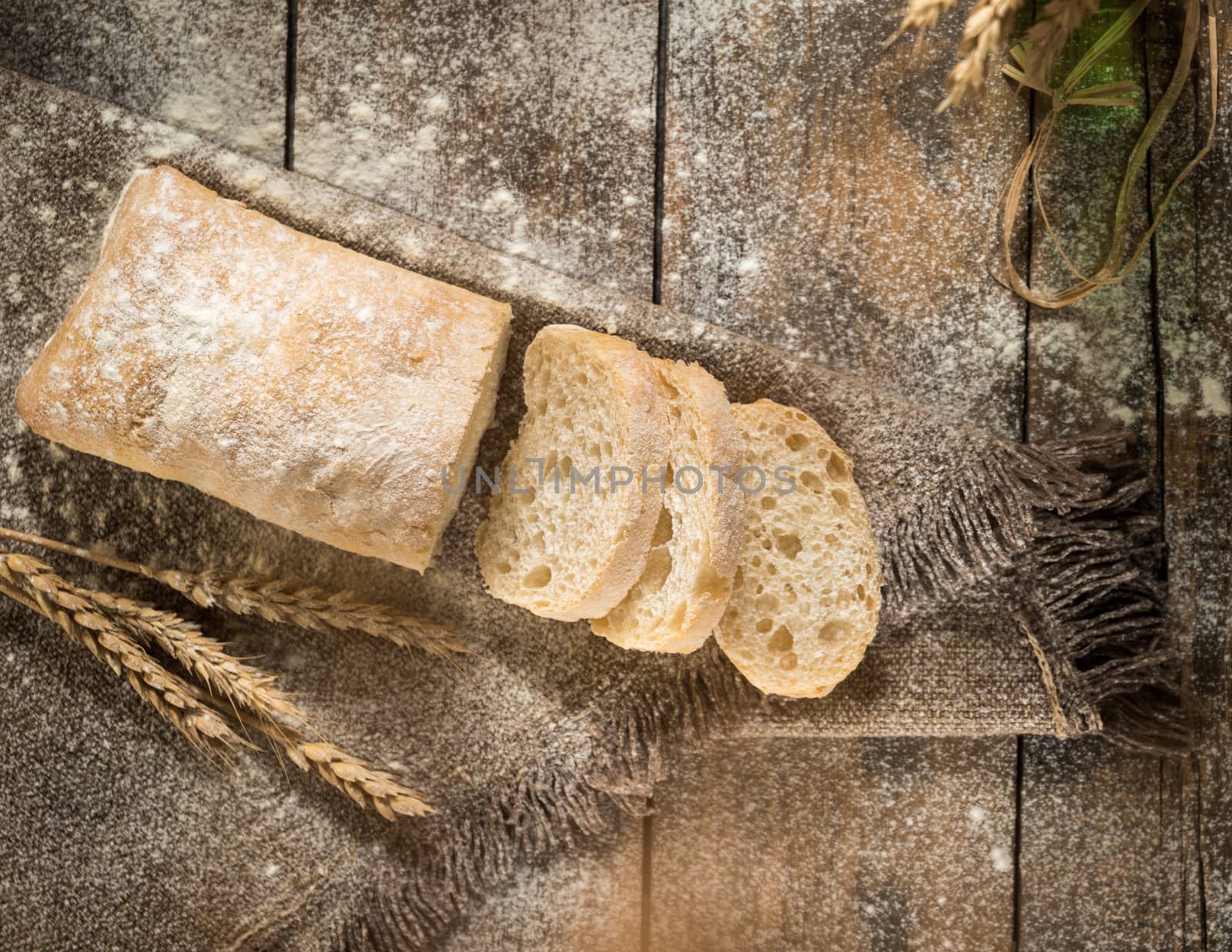 sliced white bread on a cloth napkin dusted with flour, top view