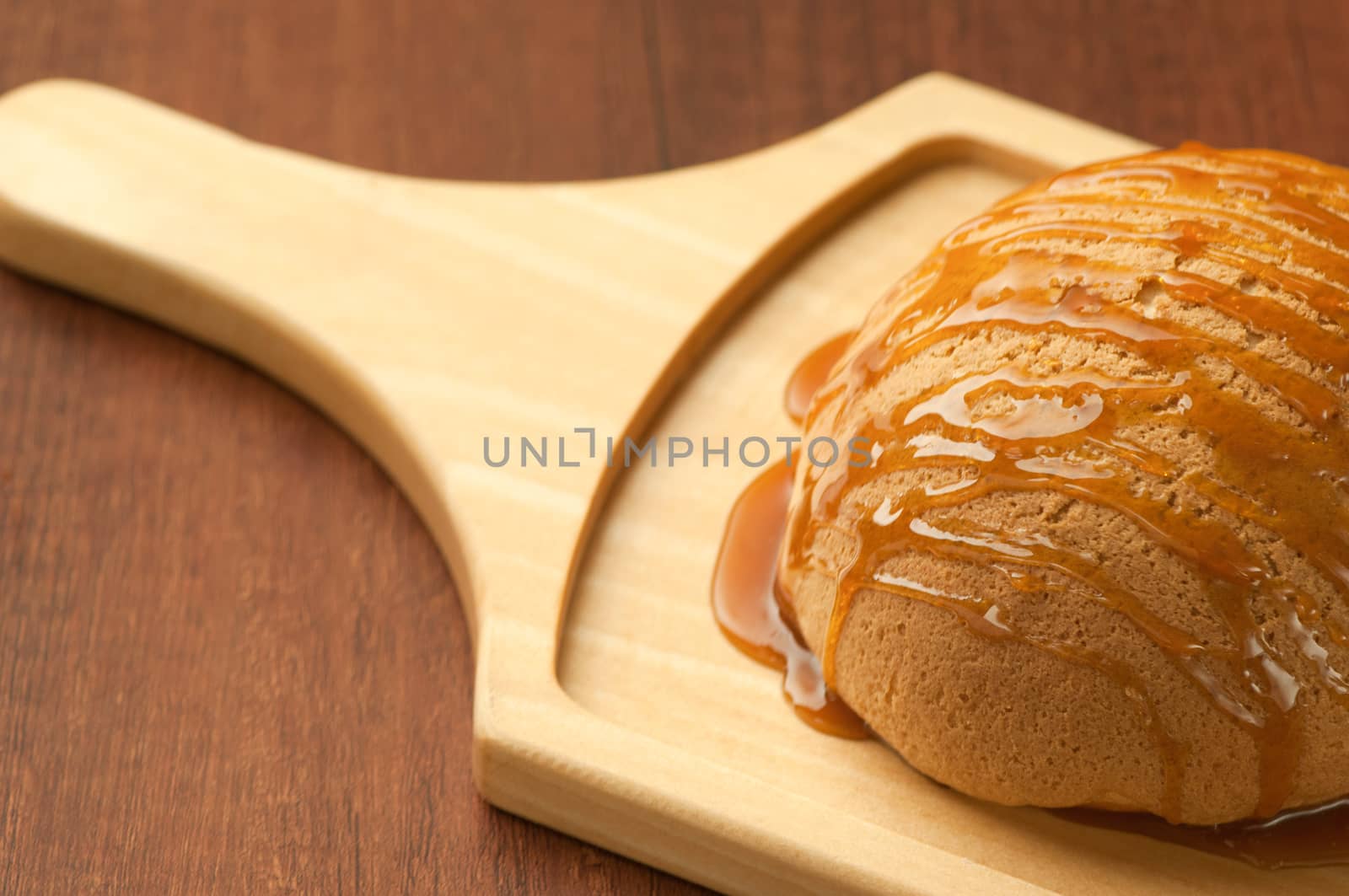 bread drizzled with honey on wooden board closeup