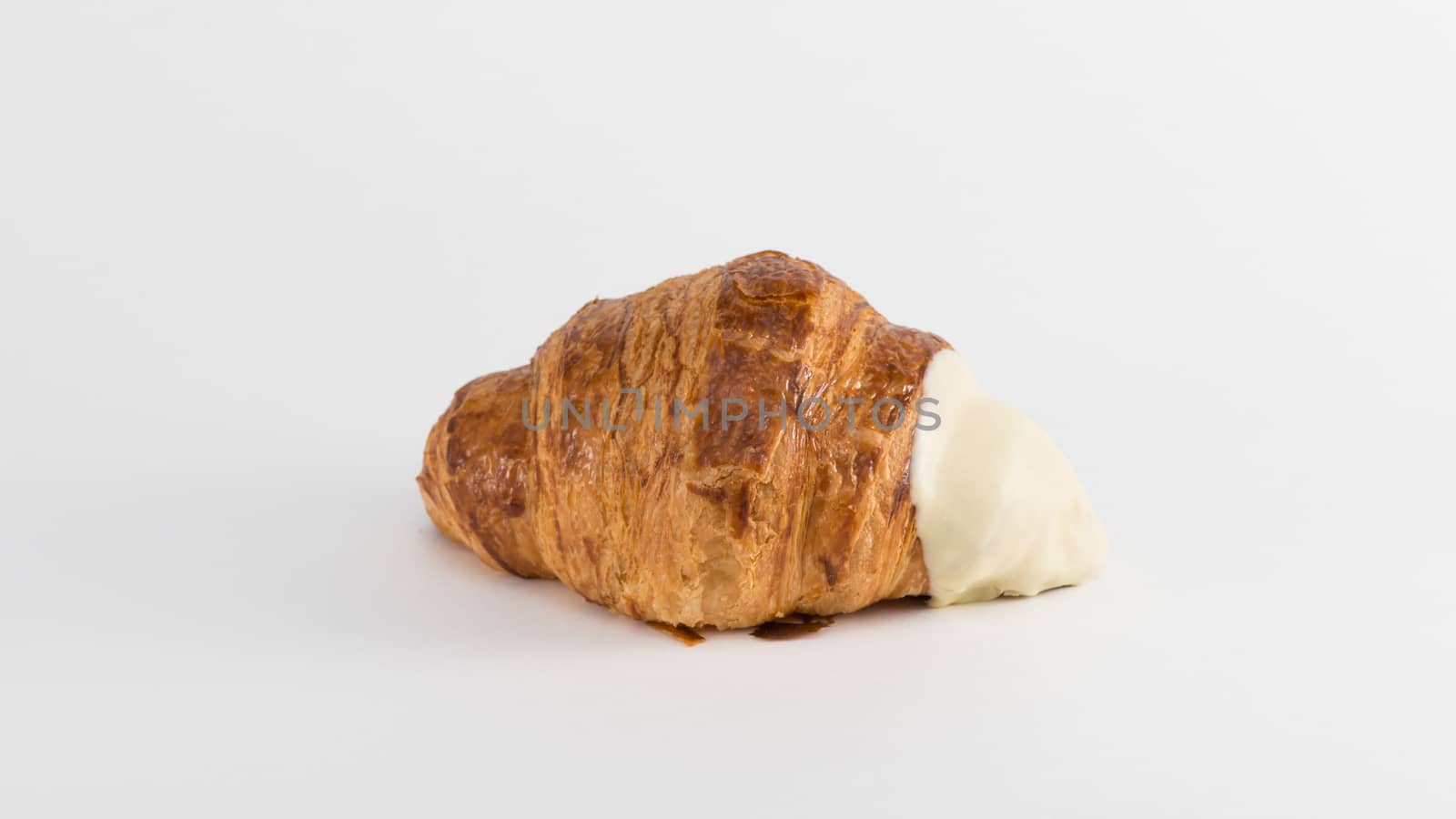 croissant with cream filling on a white background