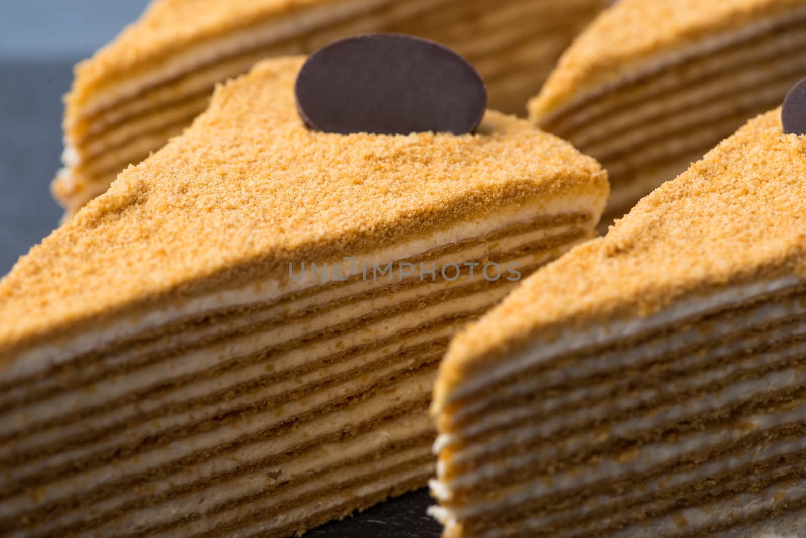 appetizing cake on a black plate, close-up