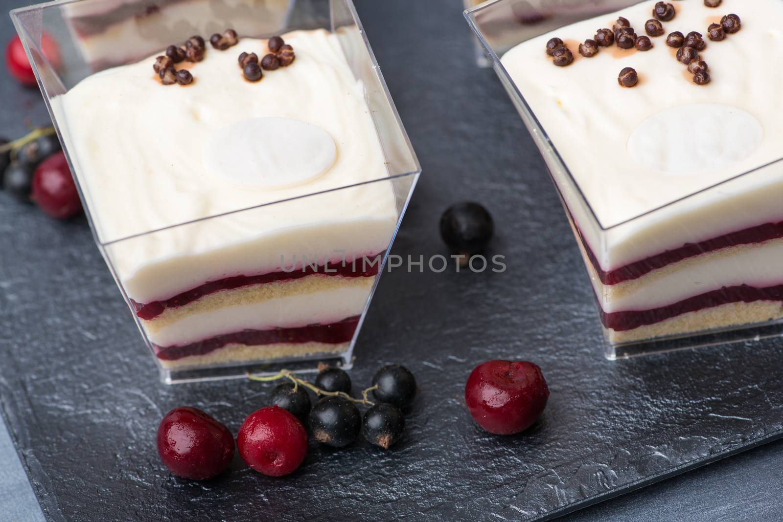 ice cream with berries in a square plastic cup, close-up