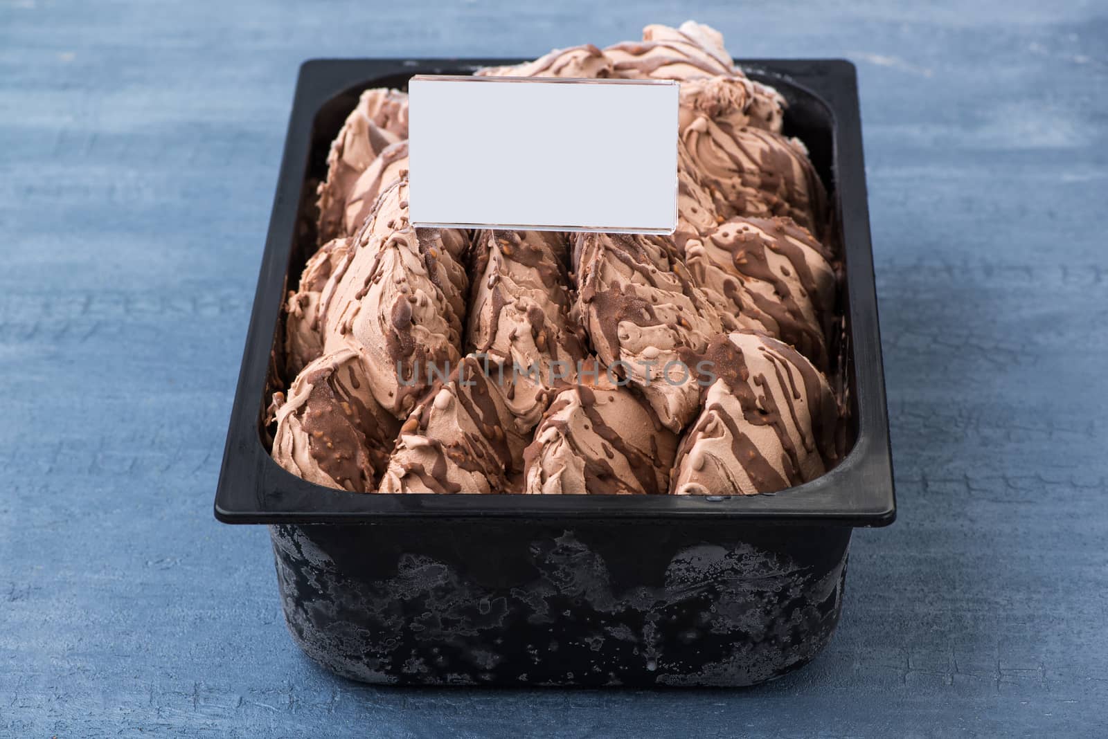 appetizing ice cream in a plastic container with a price tag on a decorative blue background