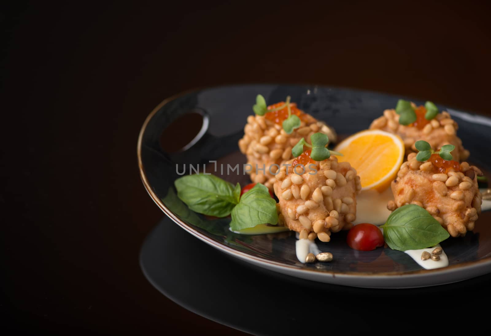 meat dish with nuts on a black background, isolated