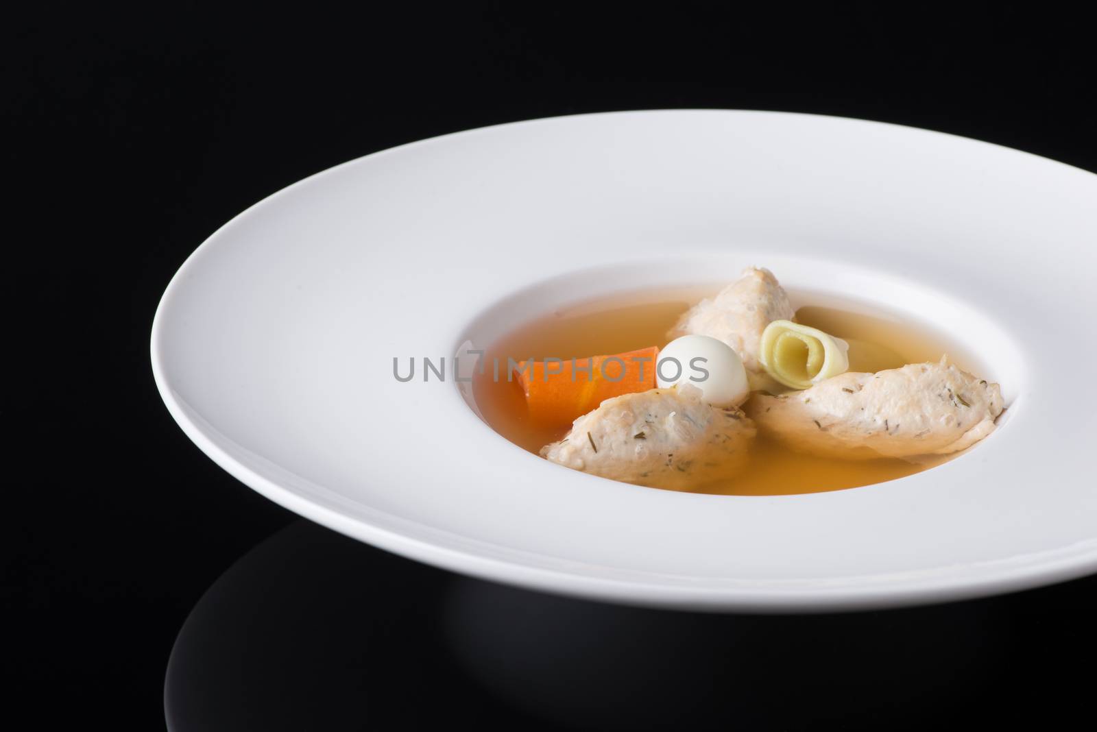 soup with meat in the test on a black background