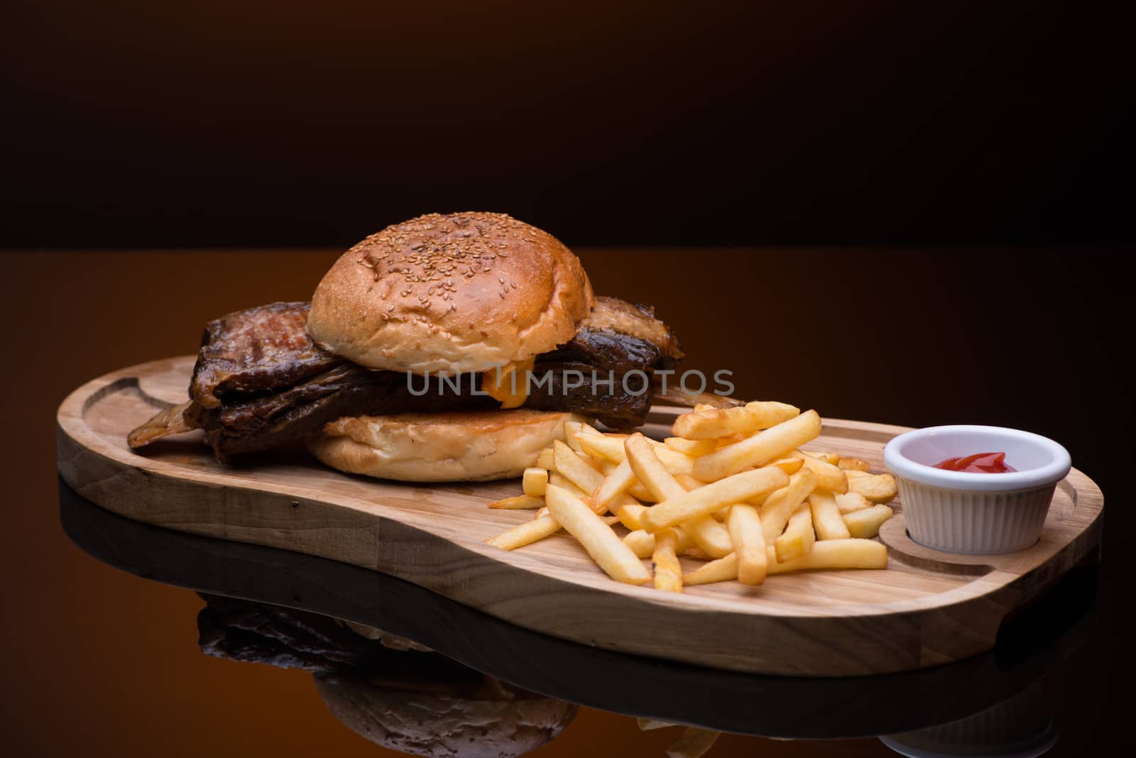 roast meat with french fries on a wooden tray