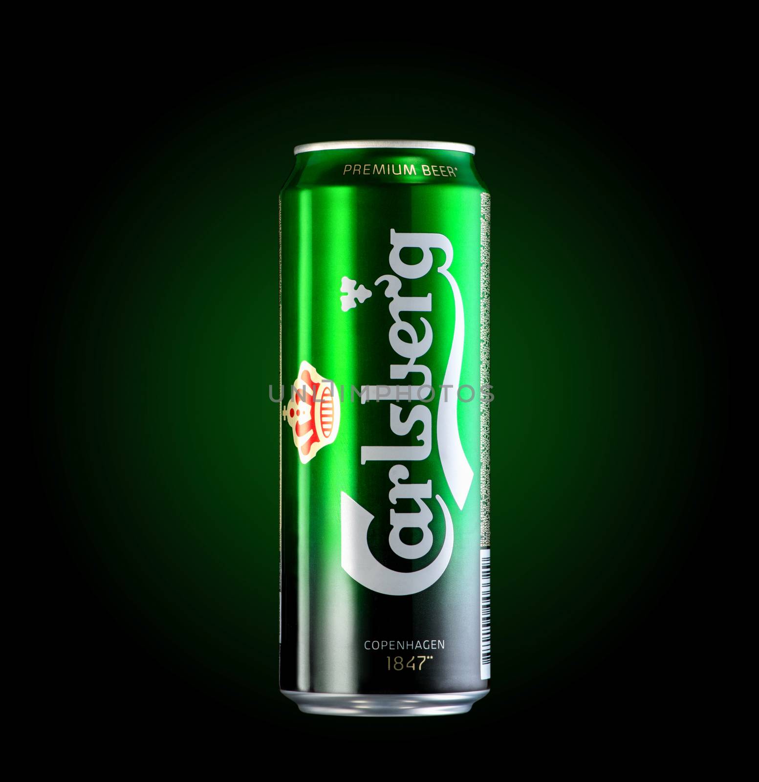 Almaty, Kazakhstan - October 11, 2019: can of beer Carlsberg in a green background with illumination. Advertising a brand of beer