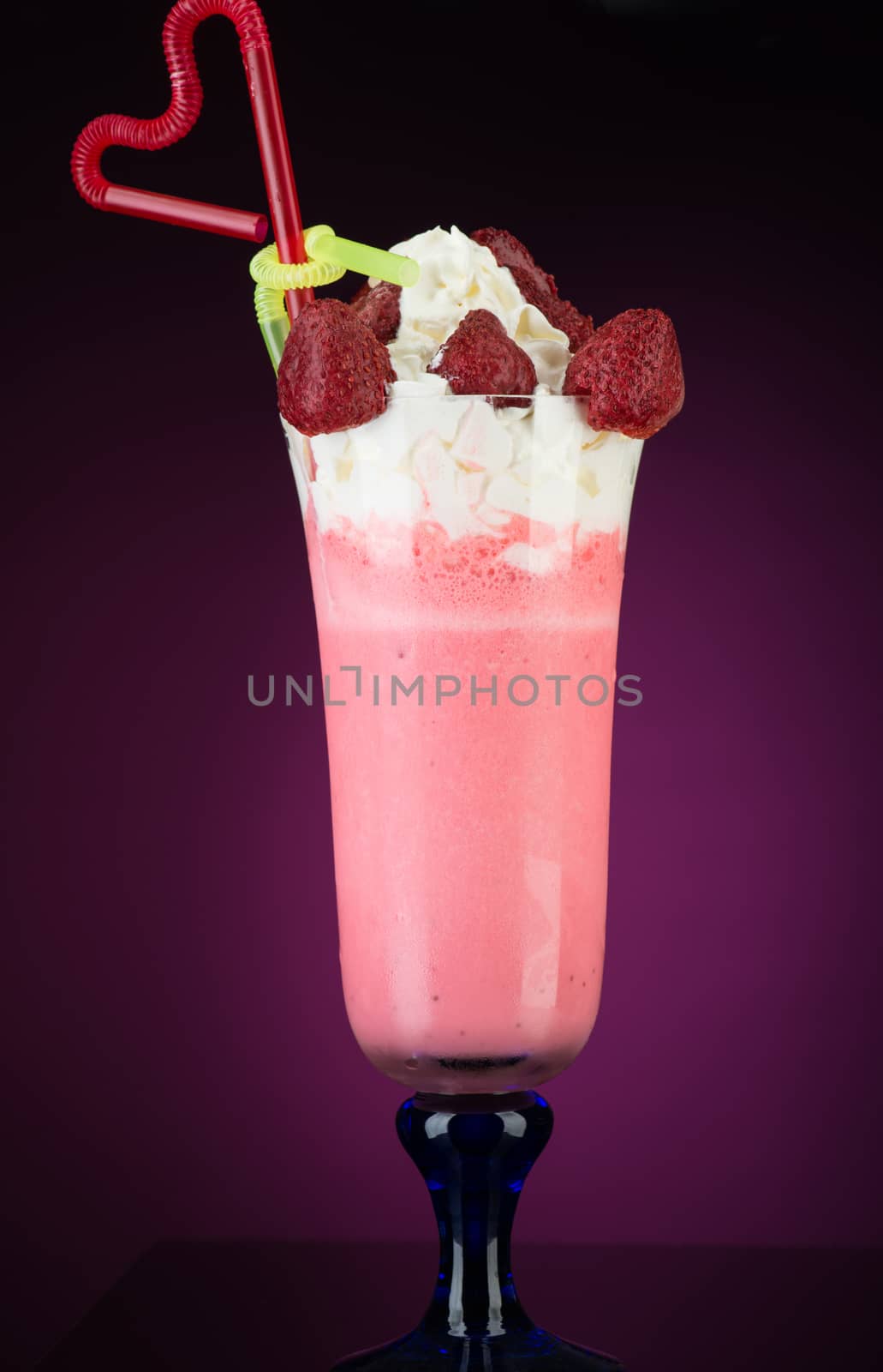 fruit cocktail ice cream with straw on red background, isolated. summer tropical smoothie