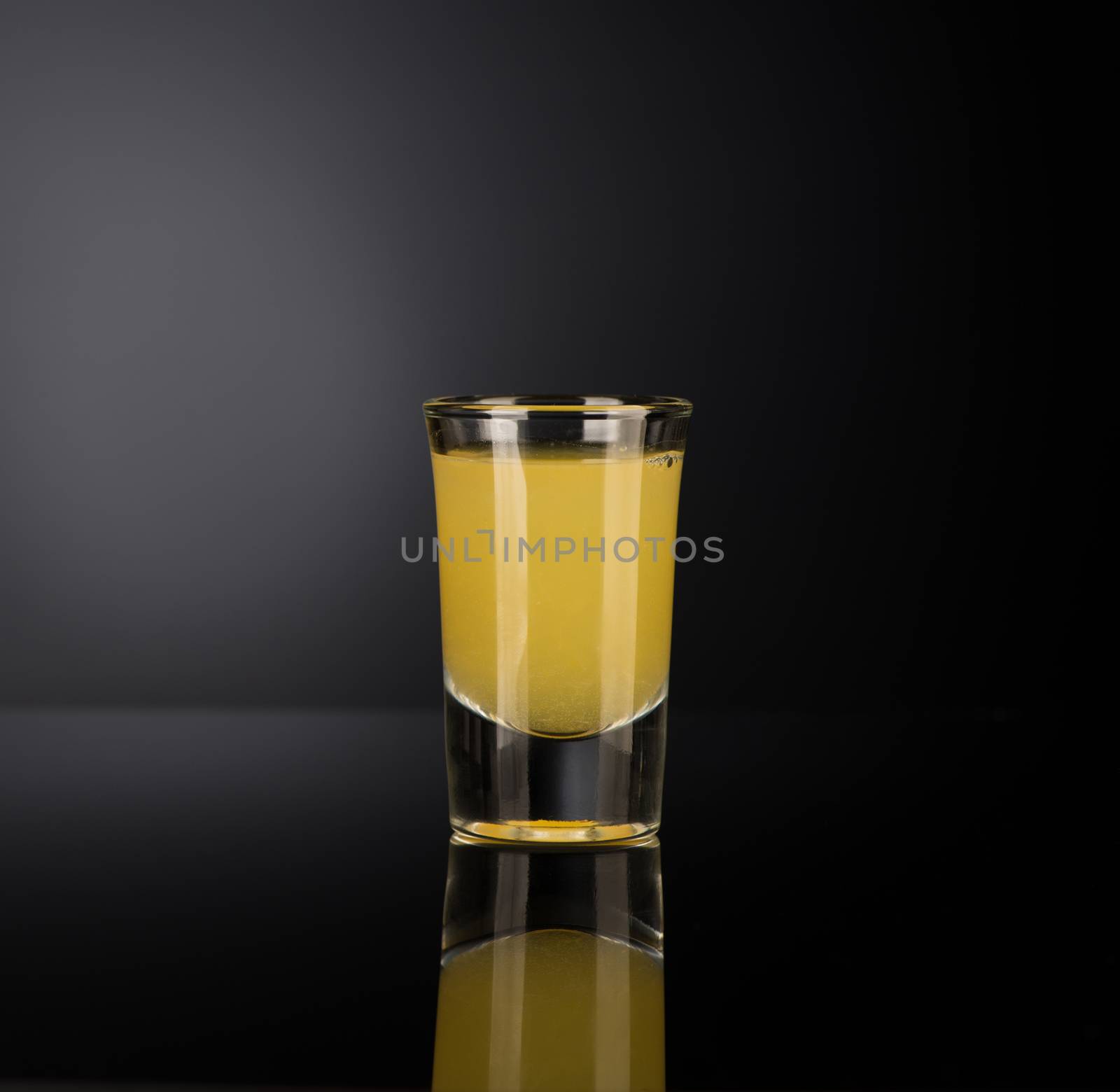 shot glass with alcohol on a dark background by A_Karim