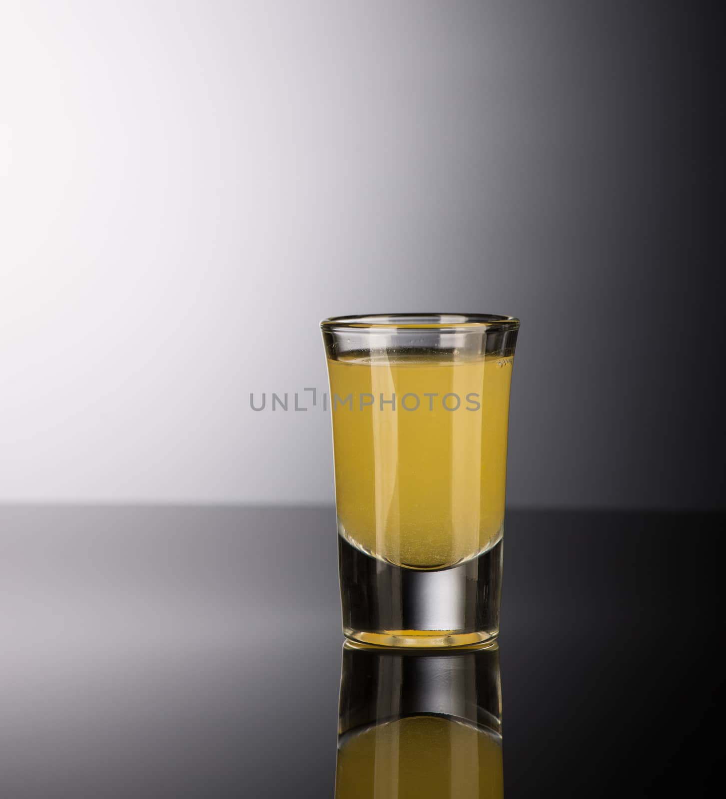 shot glass with alcohol on a dark background by A_Karim
