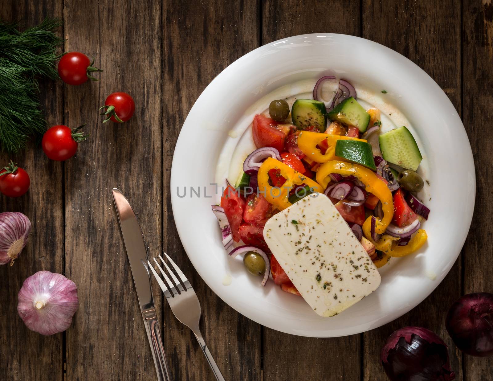 salad vegetables and cheese on wooden background, view from the top