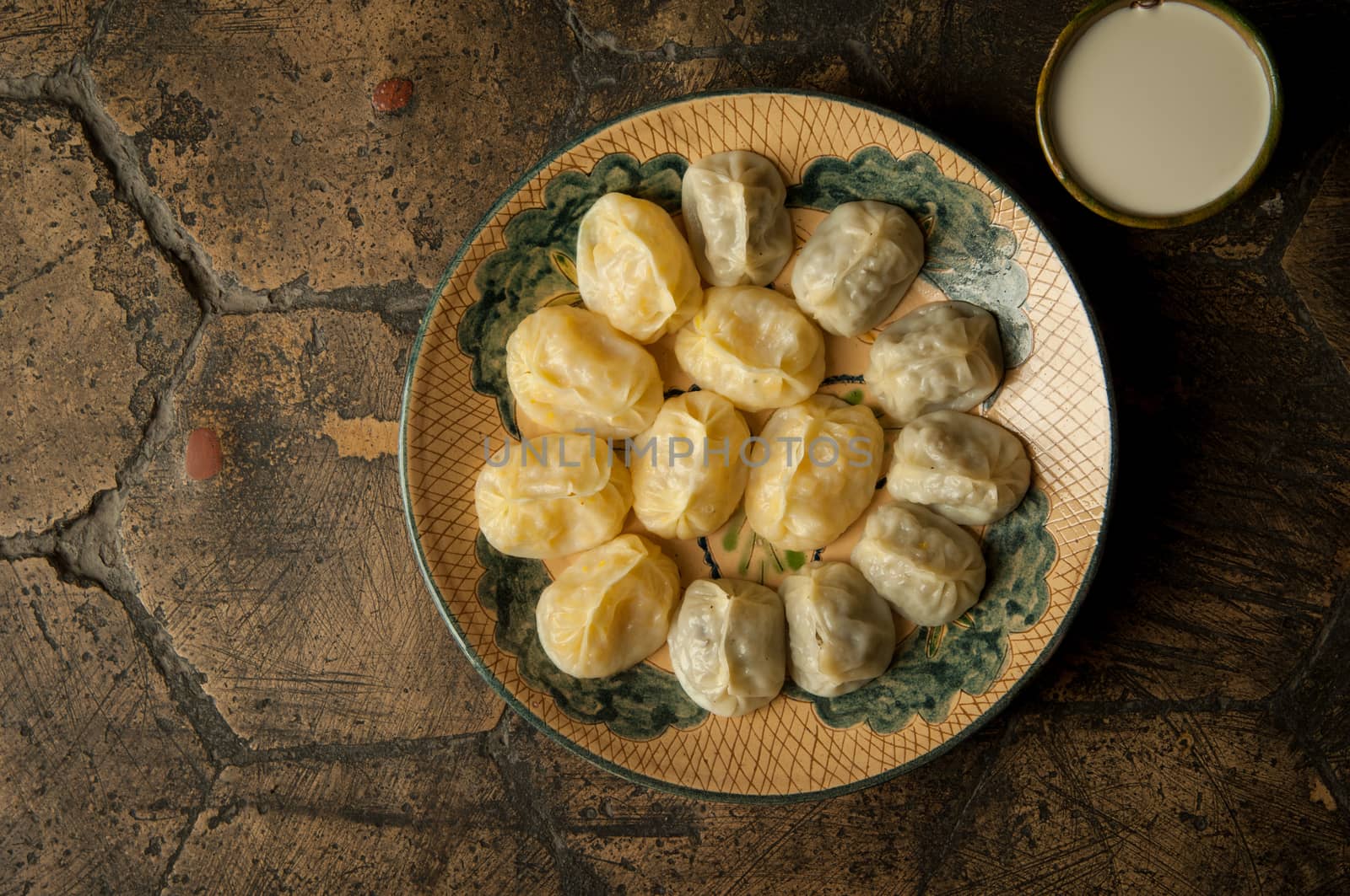 oriental dishes on decorative old tiles. meat in a test on a decorative old paving stone