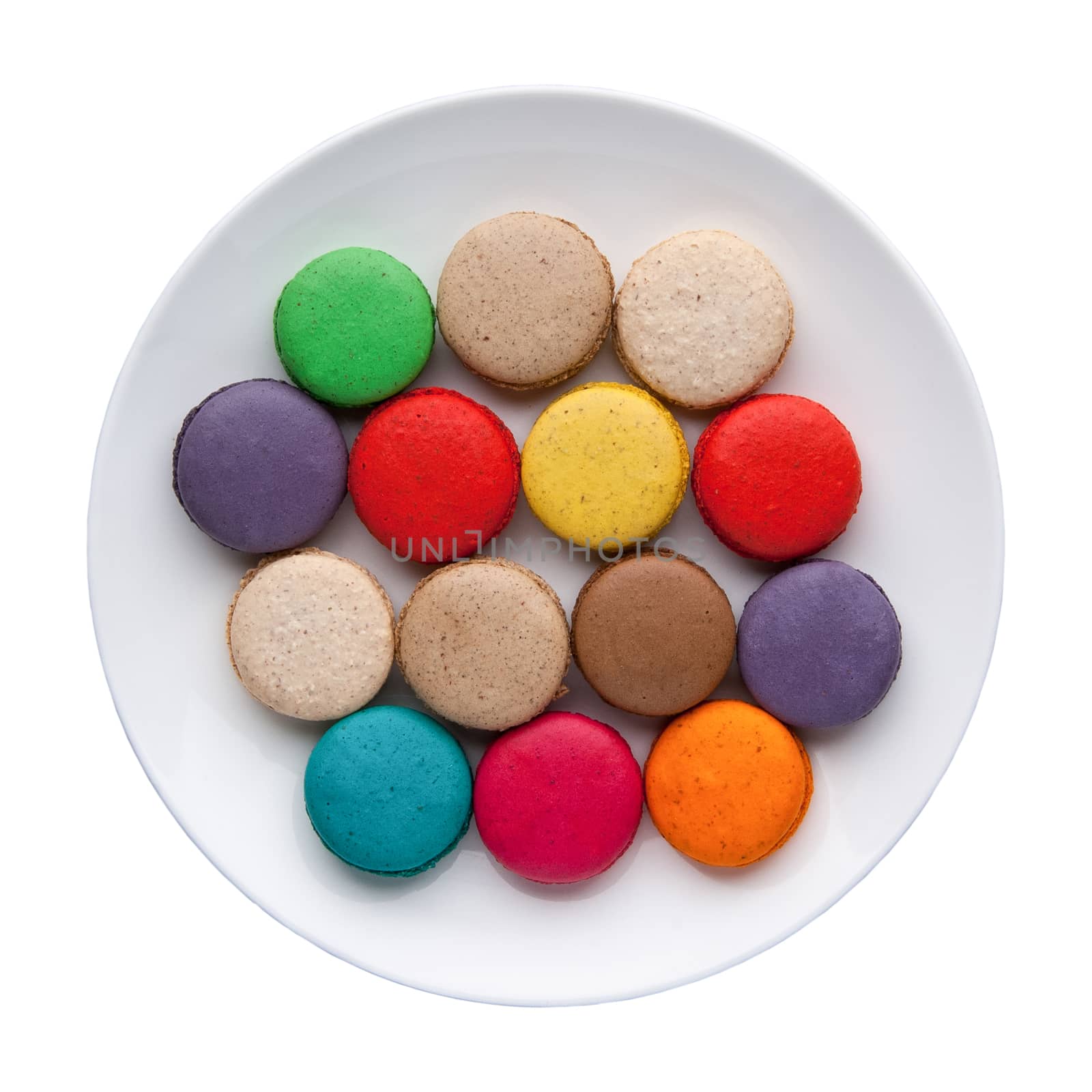 colorful macaroons in a plate on a white background. Top view. Isolated