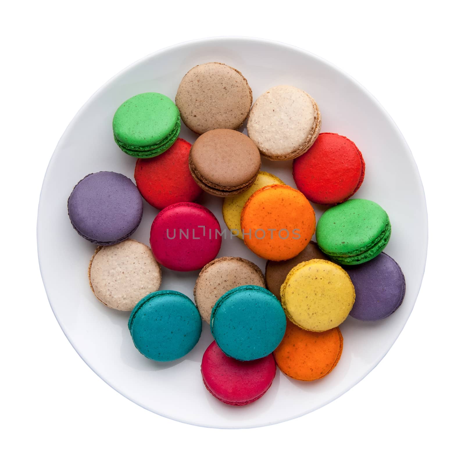 colorful macaroons in a plate on a white background. Top view. Isolated