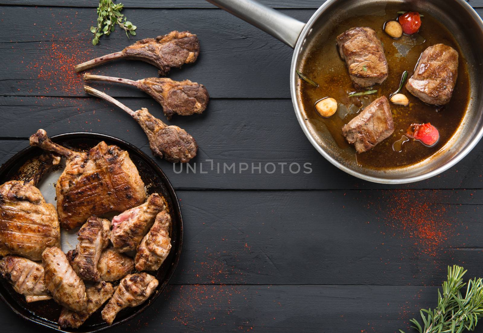 roasted meat in a pan on a black wooden background