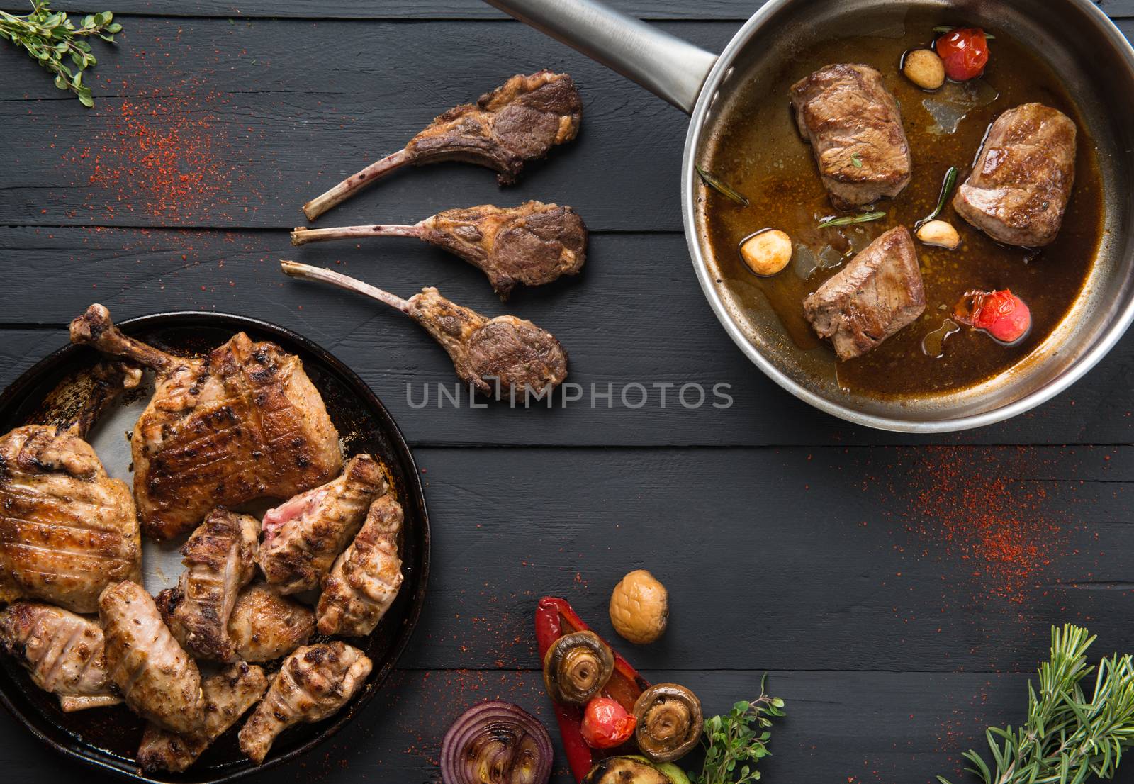 roasted meat in a pan on a black wooden background