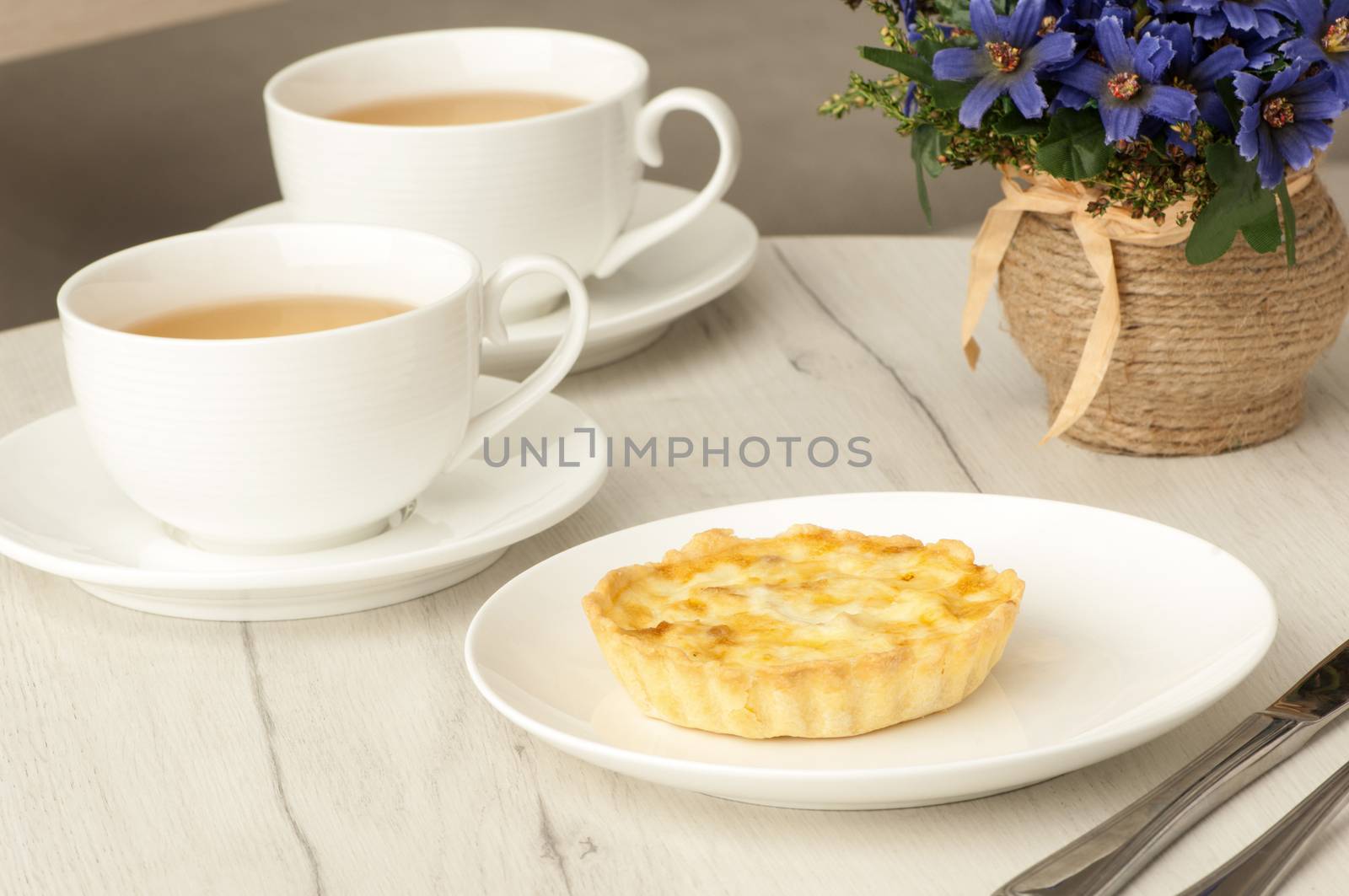 cake and cup of coffee with flowers on the table