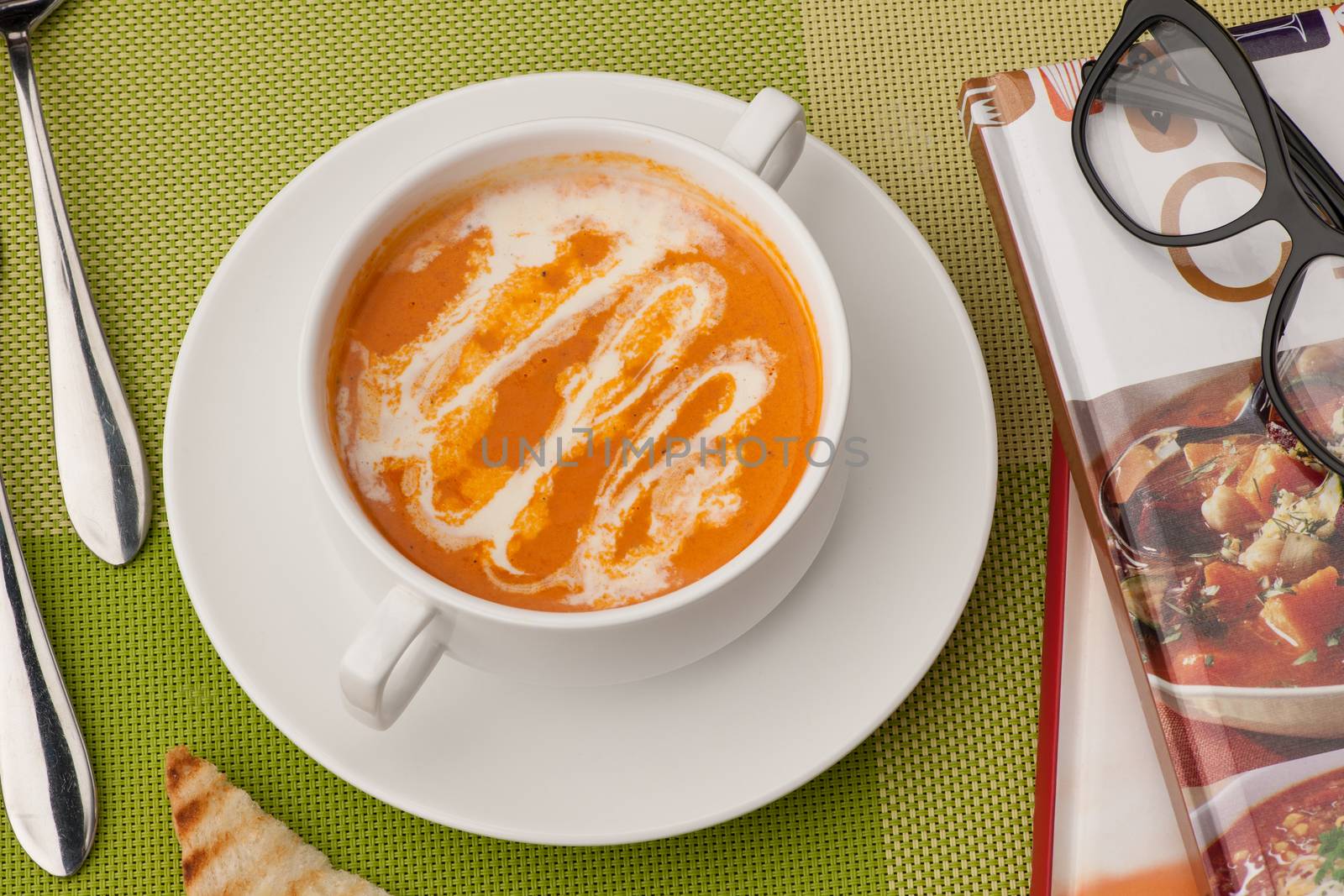 soup and a book on a green tablecloth by A_Karim