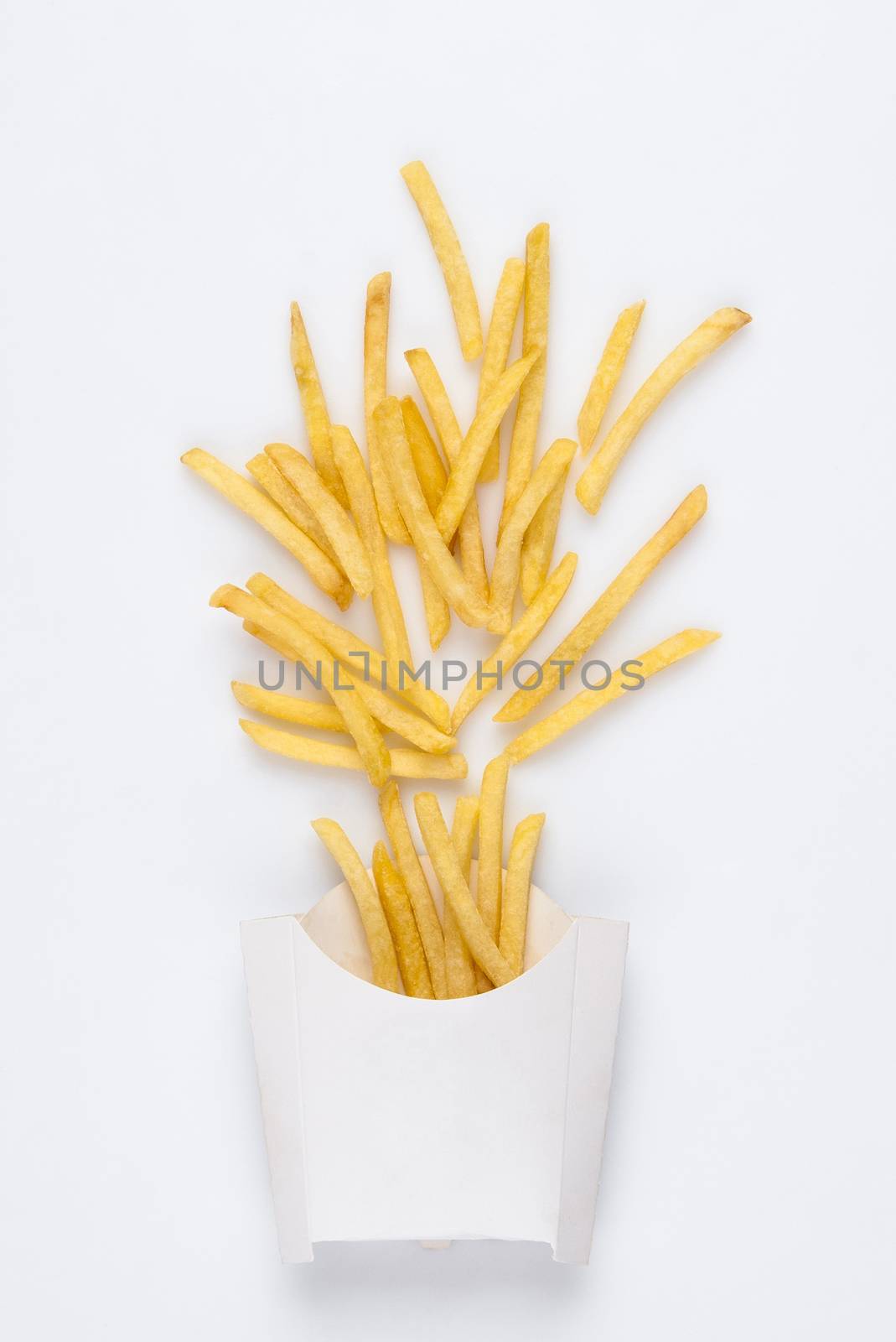 on a white background fried french fries in a white box. studio photo of fried french fries on white background