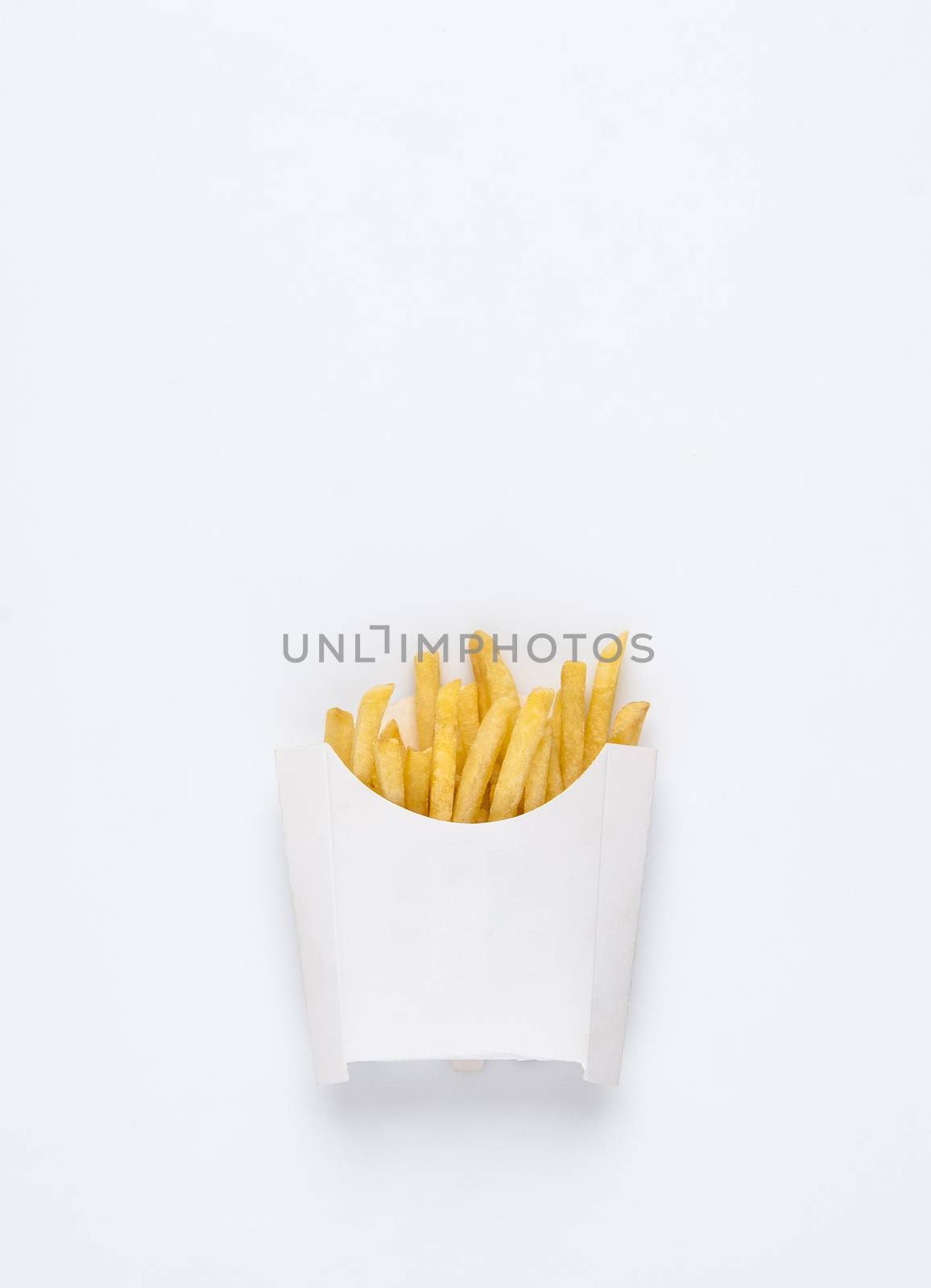 on a white background fried french fries in a white box. studio photo of fried french fries on white background