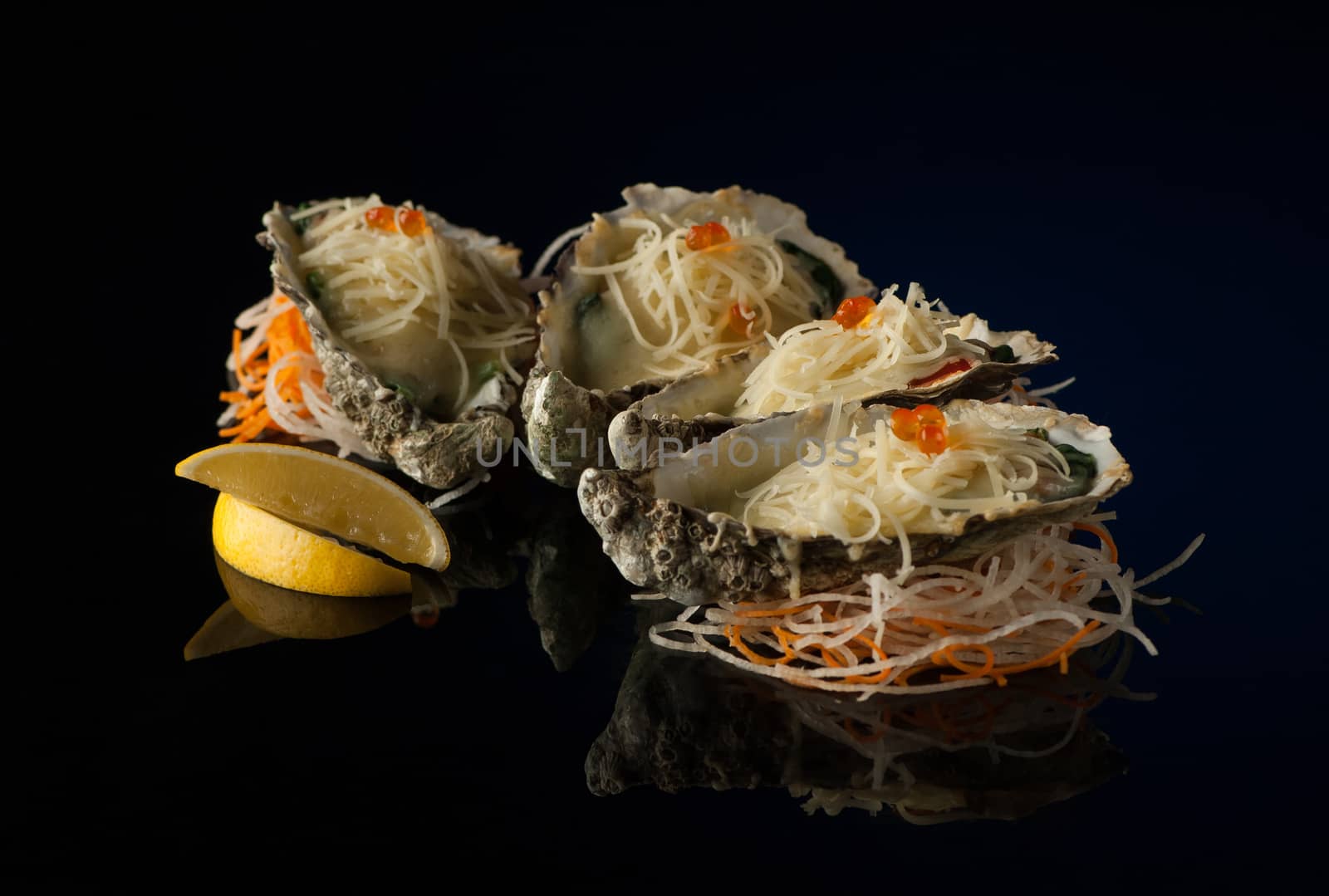 seafood and mussels in a shell with melted cheese and lemon slices on a black background with reflection. mussels in a shell with salad on a dark background