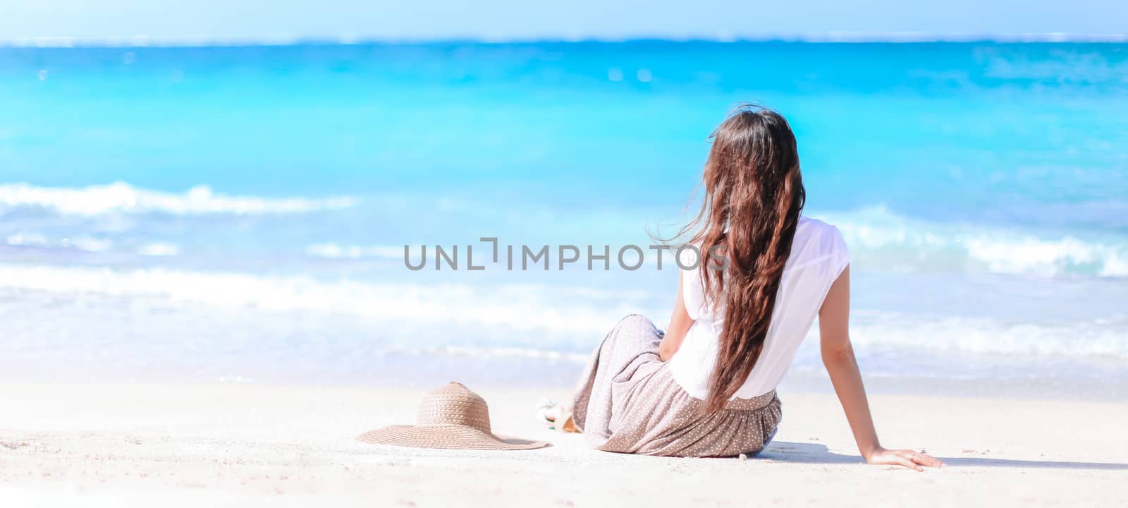 Young fashion woman in green dress on the beach by travnikovstudio