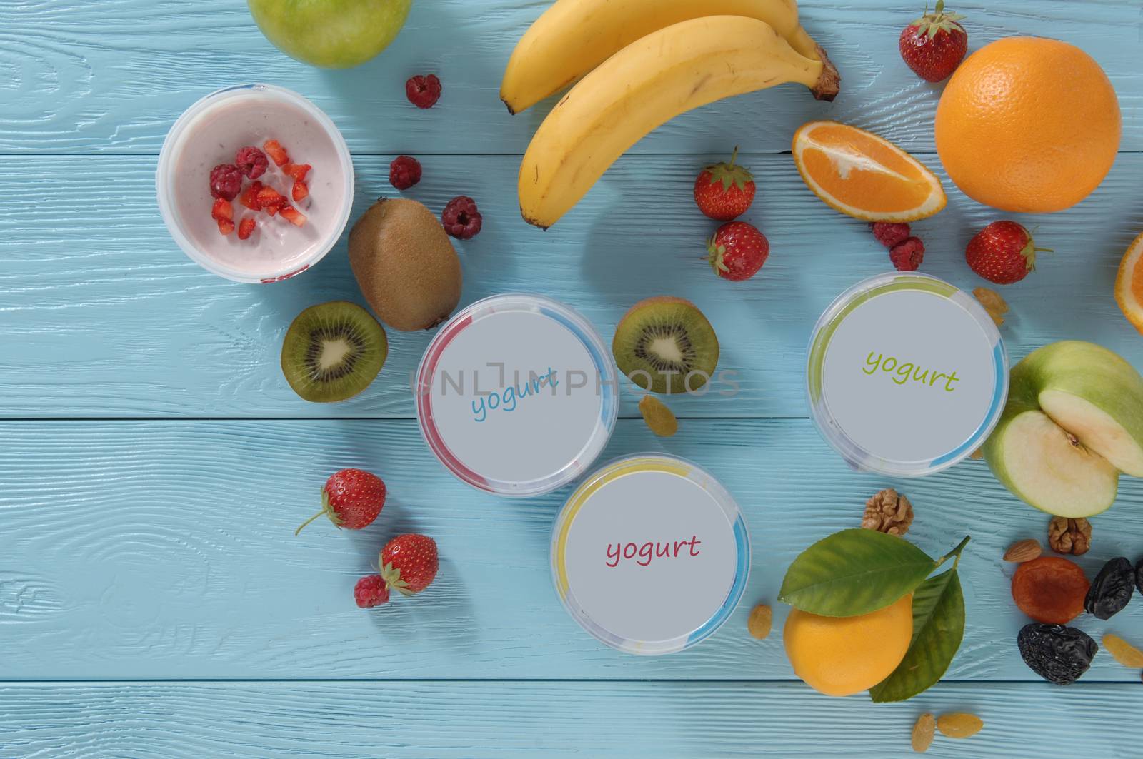 yogurt in a container with tropical fruits on a wooden background, top view. healthy eating concept