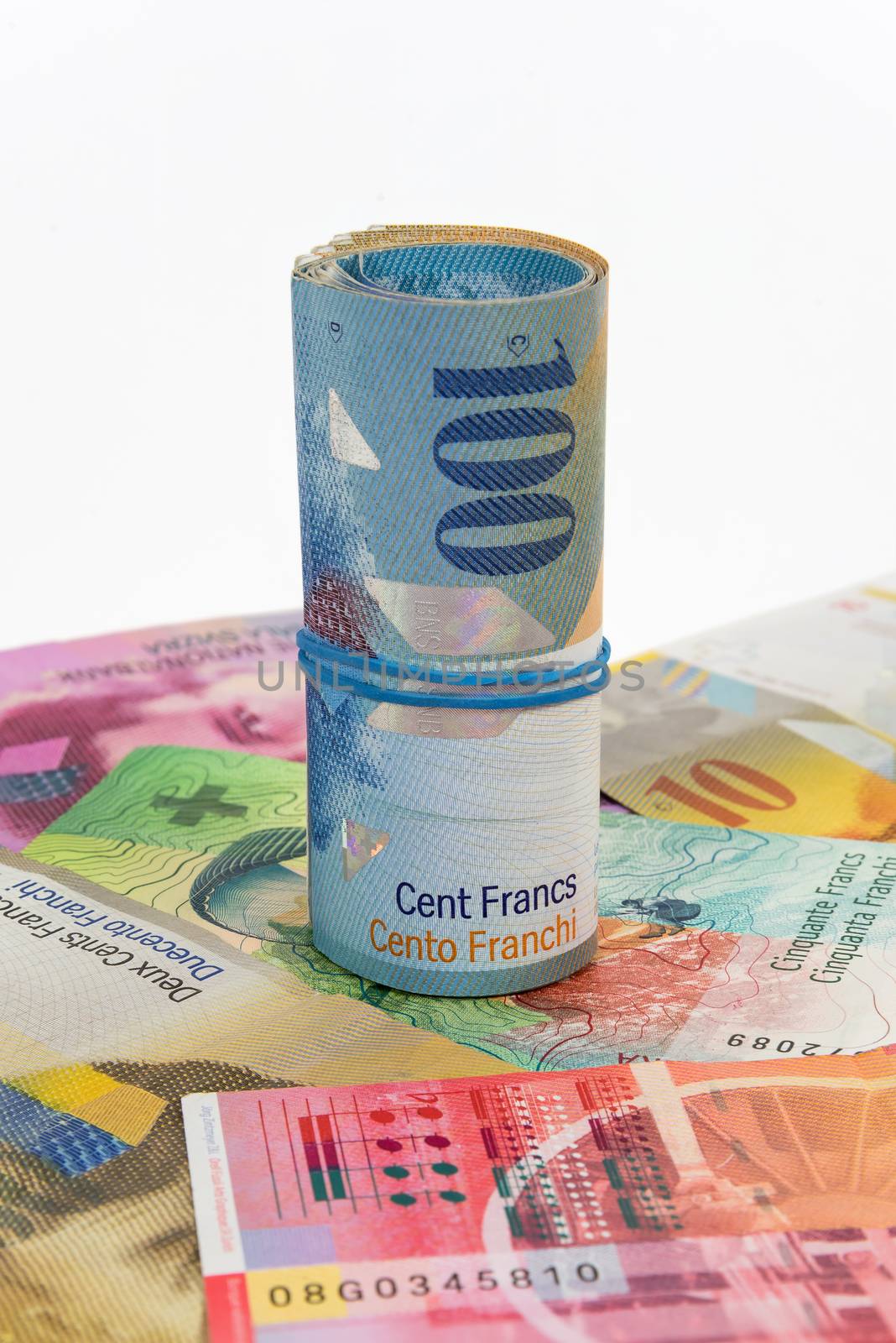 Banknotes of 100 swiss franc rolled with rubber by mkos83