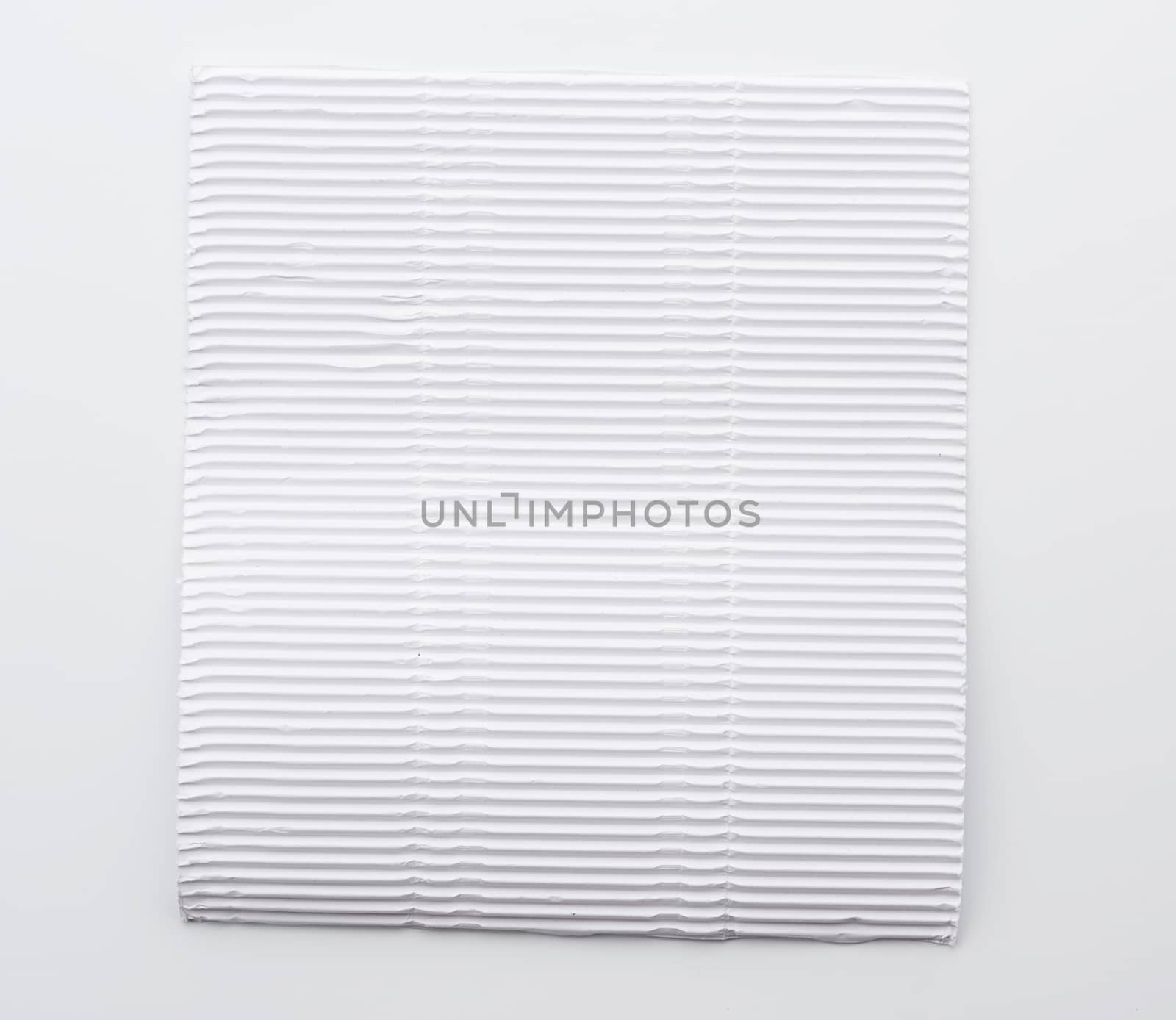 white blank corrugated paper sheet on white background , close up