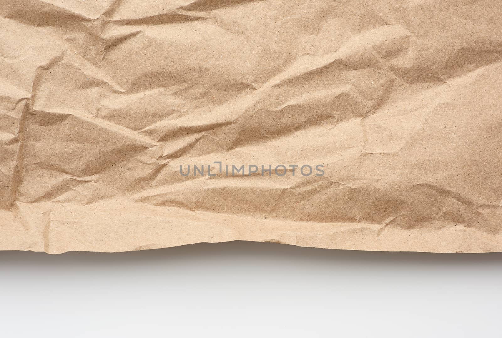piece of crumpled blank sheet of brown wrapping paper. Grunge texture. kraft paper texture.